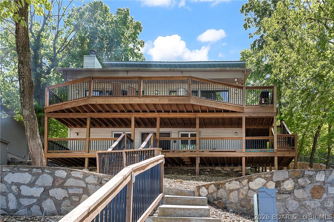 Coveted Cartwright Cove location - living on entry level, lots of parking and deep water equals the ideal lake home. Newer HVAC, water softener, and 2 new water heaters, open floor plan with walls of windows to drink in the lakeview. Cathedral ceiling, wood burning rock fireplace, tile floors, custom cabinets and a gas burning stove area a few of the features. One boat slip has has been decked in to create more entertaining space on the dock but can be converted back.