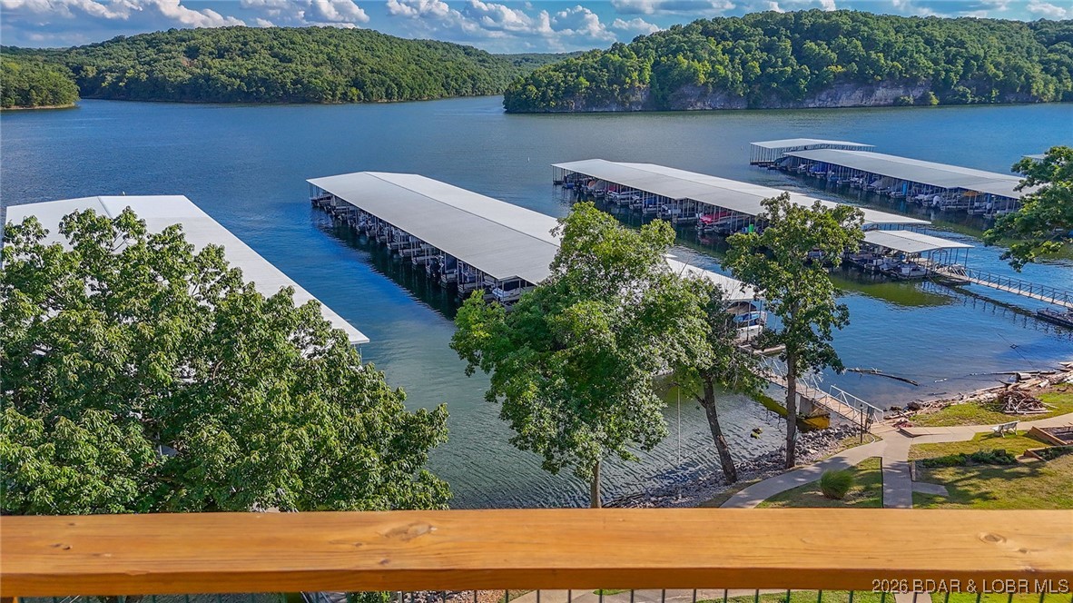 Four bedrooms and a boat slip on the water for 335K!!  Don't miss this one!   
Enjoy all the lake has to offer with this charming 4-bedroom, 3-bathroom top-floor, end unit condo!  Located just minutes from the Lake of the Ozarks State Park, this unit features breathtaking views and generous space for relaxing or entertaining.  The main floor includes an open concept living area, three spacious bedrooms, and two full bathrooms. The loft level offers a private fourth bedroom ensuite and a second living space, ideal for guests, a media/game room and more!  Interior updates include new living room flooring, a newer HVAC system, and fresh paint throughout. Offered completely TURNKEY, this condo is move in ready so you can start enjoying lake life right away!  Community amenities include a community dock, boat slip, outdoor pool, a workout room and plenty of green space!  Rentals are allowed, making this a great option for personal use, investment, or both.  For convenience, condo can be accessed by either a blacktop road (Whispering Oaks) or a gravel road.