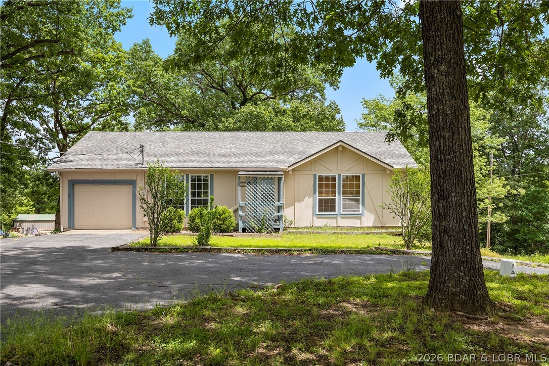 Conveniently located near town on paved road is a nicely done 2 bed 2.5 bath house, freshly painted, new carpet. A true pride of owner ship. This house is move in ready clean as a pin. There is a large unfinished basement that could be a huge game room or a guest house with its own entrance down stairs. The main level has a nice screened patio.