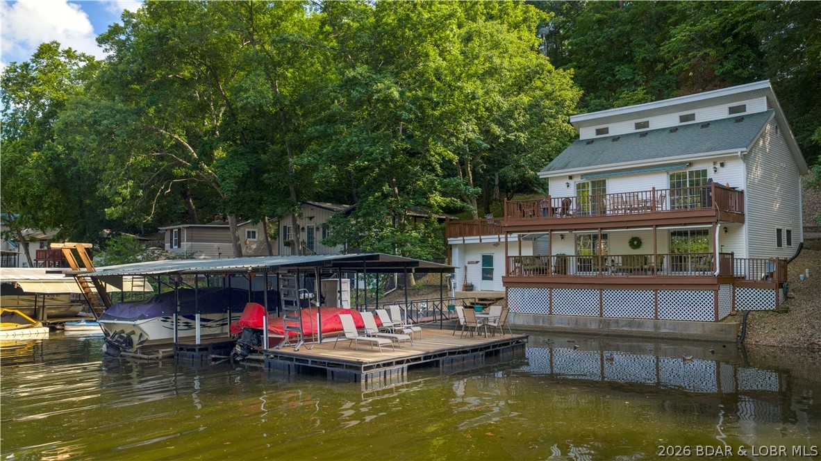 700+ Feet of Lakefront • 3.3 +/- Acres • Cove Protection • Gravois Arm. Turn-Key. Boats available, too.
A rare opportunity to own over 700 feet of shoreline and small acreage on the highly desirable Gravois Arm of Lake of the Ozarks. This meticulously maintained 4-bedroom, 2.5-bath home offers the perfect combination of privacy, waterfront enjoyment, and room to gather.
The well-designed floor plan includes two loft areas, providing flexible space for additional sleeping, recreation, or home office use. Every detail has been exceptionally cared for, and the home shows like new.

Outside, you'll find a beautiful park-like setting with mature trees, gentle lakefront, and outstanding outdoor living space. The protected cove location offers calmer waters for swimming, paddleboarding, and family fun, while the private dock with boat hoists is ready for your lake adventures. You will love the boat house/workshop. 
Great parking accommodates guests and lake toys with ease. Whether you're searching for a full-time residence or private retreat, this one checks all the boxes—acreage, extensive waterfront, protected cove, dock, boat hoists, privacy, and a prime Rocky Mount location.