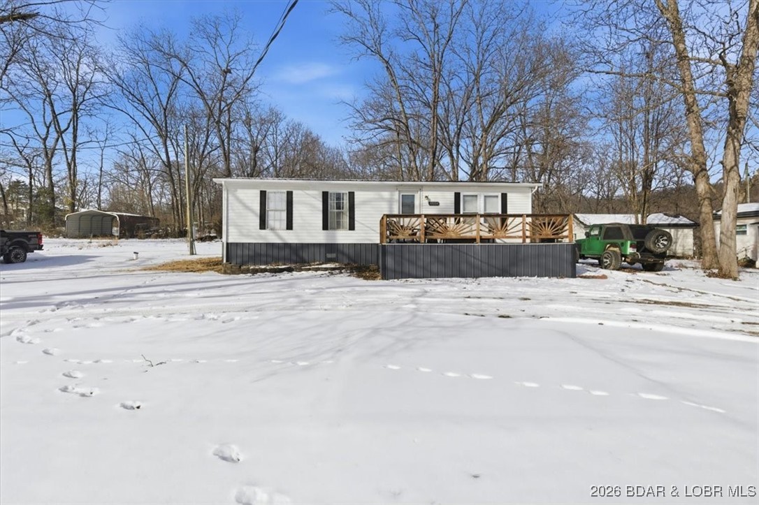 Welcome to this beautifully remodeled 3 bedroom, 2 bathroom second tier Lake Home! Stunning Lake views year round. Home offers a bright living room where you can sit and enjoy your stunning views of the Lake of the Ozarks. Convenient one level living with an eat in Kitchen. Comfortable size bedrooms with a large primary bedroom and bathroom for the perfect amount of privacy.  No HOA!