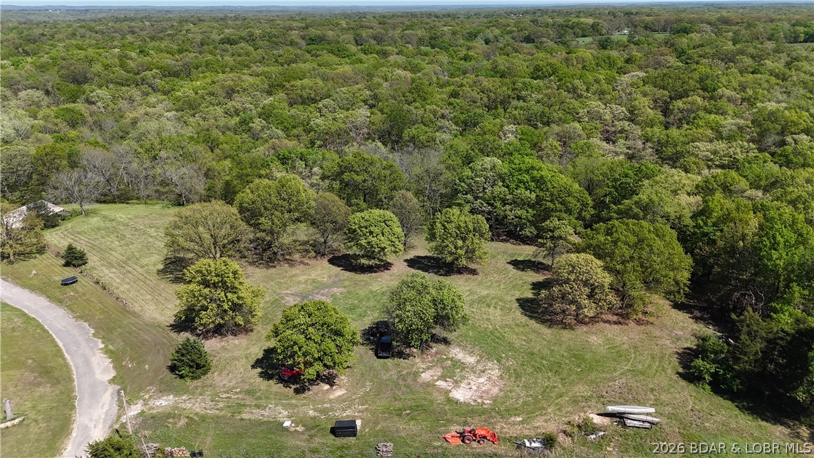 28 Prater Rd, Eldon MO.Very Private! Not just raw 85 acres, its a versatile piece of the Ozarks. Large White Oak, and Walnut timber, open meadows, spring creeks, and a stocked spring fed pond. There is a 100 plus yard shooting bench & range. A nature lover/hunter paradise (pictures to prove it). Mutiple hunting stands, game plots, and drivable trails. There is a large 2240 sq ft 3 bd & 2 bath manufactured home, with wood burning fireplace, currently being rented. A 36x24 shop with concrete floors, electric, and a 36x12 lean to on one side. The driveway is asphalted, large shade trees adorn the yard. Several beautiful home sites, open pasture, and garden site. Property is 5 minutes from Eldon, and 12 mins to Lake of the Ozarks. Eldon is known for its small town atmosphere, great job opportunities, multiple Medical facilities, and a great school system. Agent Owner.