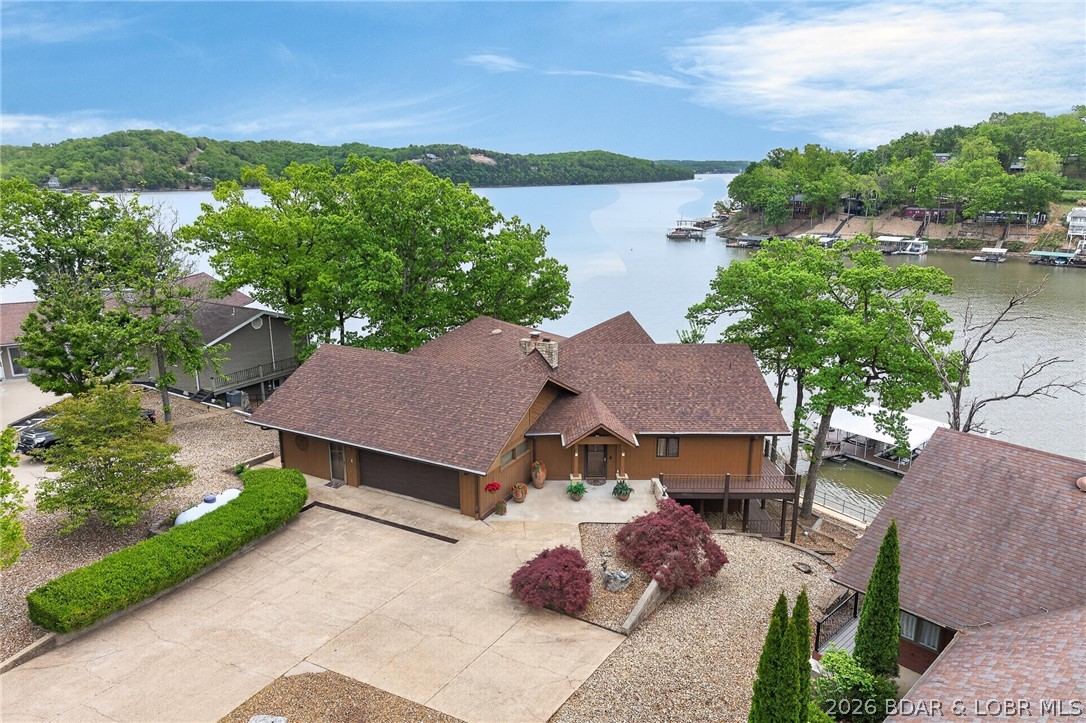 In Greenview Area @ 32½ Mile Marker on Osage Arm of Lake of the Ozarks—LOCATION-LOCATION! Meticulously Maintained 3,867SqFt Lkfrt Home offers SO MUCH: A Wide Vista of Impressive Main Channel Views & of (no-wake) Standing Rock Hollow Cove. 104Ft Shoreline w/ Lkfrt GAZEBO & Lkfrt Boardwalk. INSIDE: Walls-of-Lakefront-Windows to View & enjoy Mesmerizing Lk & 2Well Dock from Din’g Rm, Kitch, 2 Levels of Liv’g Areas, ALL Bedrms & 2 Levels of Wrap-Around Covered Lkfrt Decks. Light-&-Bright Hm w/Abundance of Cheerful Natural Light'g. Pride of Ownership Evident upon Arrival into Coveted BOYD SUBDIVISION. 3 Bdrms (+Could Convert Office & Stg Area in Garg into 4th Bdrm), 2 1/2 Bath, Frpl, Impressive Gorgeous FULLY REMODELED GOURMET KITCHEN (Will win Anyone Over), Granite, Custom Cabinets w/Lead Glass Panels, WOLF Stove, Dbl Ovens, Built-in Bakers Mixer Station. Pullout Panty Shelv’g, Eye-Level Dishwasher & more. Attached 2 Car Garg w/Extra Storage Area. Lovely Landscape, Lots of Prk’g. A Commt’y Park. A Marina & 2 Lakefront Venues in this Cove. Just Min’s to MANY Lkfrt Venues by Boat & 10-15 min Drive to Shop’g, Restaurants, Town & Schools. See EXTRA FEATURE SHEET