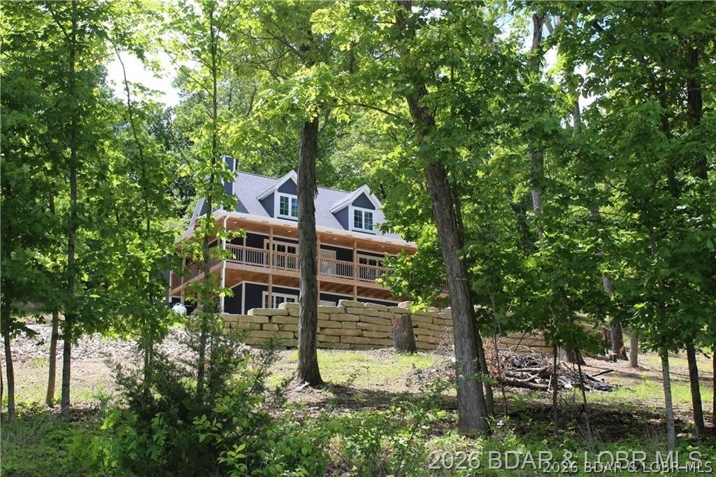 NEW CONSTRUCTION - MOVE IN READY! New Concrete driveway with extra parking completed 2026!
This gorgeous home sits on 17.35 acres! Includes 3 additional buildable lots! Located at the 55 mile marker. Enjoy the stunning views, great fishing and abundance of wildlife! Private subdivision! COMO fiber internet, 12x32 covered boat slip located in the community dock!
Main floor living, Chef’s Kitchen, dining, living room, laundry and Primary Suite with full bath. The upper level has 2 huge bedrooms/loft, plenty of storage and space for the kids to play. The lower level has a walk-out basement, finished, huge bedroom private bath and much more! Also, option to purchase house with less acreage or build on one of the available 3 lots!