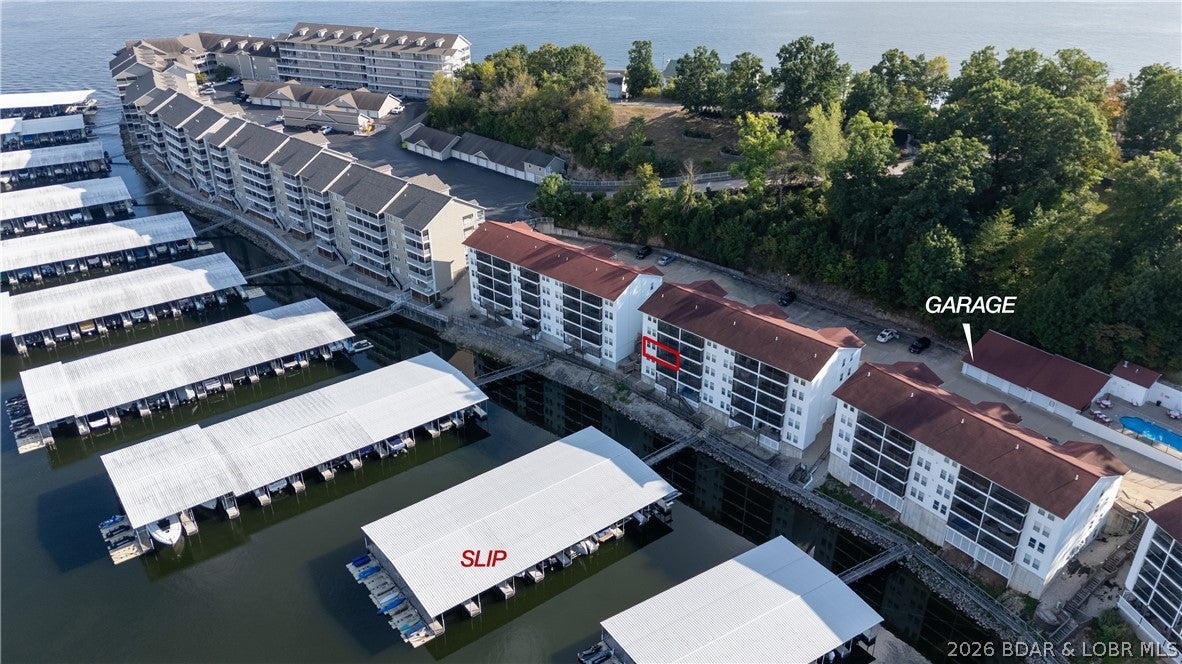 Rare opportunity to own a 3-bedroom, 2-bath end-unit, walk-in with steps at Lighthouse Landing! This recently updated, turnkey condo offers privacy, easy access, vinyl plank flooring, and a TV-equipped deck perfect for relaxing after a day on the water. The property includes a 14x32 boat slip, with a garage available for additional purchase—the complete lake package! Only five garages exist in the entire development. Lighthouse Landing offers maintenance-free living, heated swimming pool, city water and sewer, and a convenient location just minutes from Highway 54. Enjoy a peaceful cove ideal for rafts, kayaks, and paddleboards, plus a community swim platform. The condo can also be rented to help offset ownership costs. Come see this exceptional lake retreat!