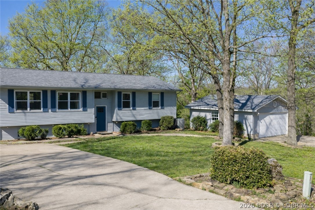 Welcome home to this spacious and beautifully updated 5-bedroom, 3-bath residence nestled on a generous half-acre lot in the heart of Camdenton! Located just minutes from shopping, dining, and everyday conveniences, this property also offers the benefit of being in the highly desirable Camdenton School District. The split-level layout provides flexible living options with master and guest room on the main level, spacious open living, and a walkout lower level ideal for family living, guests, or work-from-home needs. The lower level features 3 bedrooms, including a large bedroom with private exterior door complete with a cozy fireplace, offering exceptional versatility as a guest suite, second family room, game room, home office, or private retreat. 5th bedroom is non-conforming. Updates include newer carpet and HVAC system for added comfort and peace of mind. Outside, enjoy the large fenced backyard—perfect for kids, pets, gardening, and entertaining—plus a detached 2-car garage and storage shed for all your tools, toys, and equipment. With room to grow and endless possibilities, this inviting home is a fantastic opportunity in a prime Camdenton location.