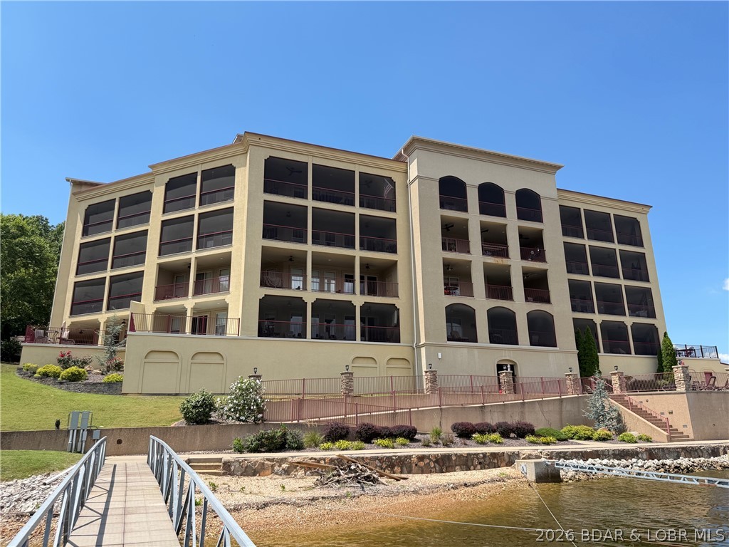Lakefront living at its finest!  Luxurious Setting with Stunning Views makes Bella Sera Condominiums so unique! This top-floor end unit boasts breathtaking views of the"4 Corners"at the 31 Mile Marker. Stunning! Tastefully decorated and ready for Lake Fun! Condo features an open floorplan with soaring ceilings, spacious kitchen w/granite countertops, 3 bedrooms, 3 bathrooms which includes a large primary suite w/jetted tub, custom walk-in tiled shower, Open living room & dining area - perfect for entertaining, screened in Oversized Patio with storage area.  Perfect setting for enjoying the panoramic lake view or just relaxing.   Step outside and enjoy the pool located on the point (Amazing views from there too), an elevator leading directly to your unit, & community dock protected by wave breaks on 3 sides, PLUS a 16X40 boat slip is included ,one reserved parking space in the underground parking garage and is furnished …. Turn-key!  This is the Total Package!!