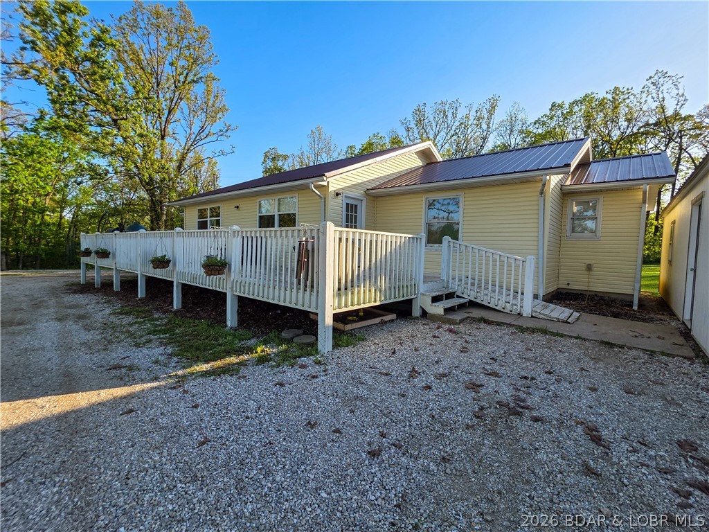 Enjoy the perfect blend of country living and convenience with this charming ranch home nestled on 3 scenic acres. Tucked just off the short gravel road, this property offers privacy, peaceful surroundings, and beautiful views.  The large yard will be great if you want a garden or a fantastic area for your kids to thrive in the outdoors. The inviting front deck is the perfect spot to relax with your morning coffee or unwind in the evening while taking in the countryside. Inside, you’ll love the open-concept layout that creates a seamless flow between the living, dining, and kitchen areas—ideal for everyday living and entertaining. The property also includes an additional storage building, providing plenty of space for tools, hobbies, or extra storage needs. Whether you work in Jeff, Eldon or Versailles, this location has you covered. You’ll enjoy the best of both worlds—rural tranquility with easy access to amenities. This property offers space, comfort, and a true country feel.