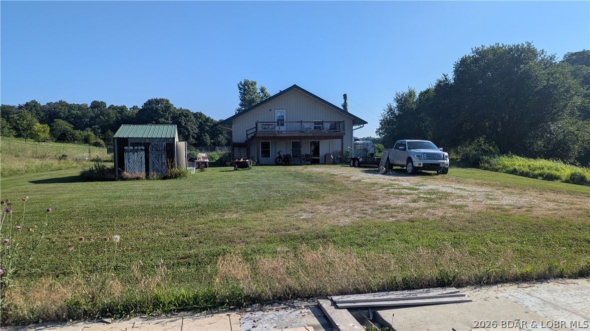Discover the possibilities on this exceptional 56± acre property offering the perfect blend of privacy, versatility, and future potential. Whether you're dreaming of building your forever home, creating a hobby farm, or simply enjoying wide-open space, this unique property is ready for your vision. A concrete slab foundation is already in place with electric, water, sewer, and fiber internet available at the pad, giving you a head start on your next build. The existing metal building features a second-floor apartment, plus a main-level bedroom or office, a full bathroom, a spacious climate-controlled room ideal for an art studio or home business, and a large shop previously used as a dog kennel and workshop. Approximately 3± acres are enclosed with chain-link fencing, providing a secure space for pets or livestock. One side of the property is also fenced along the property line, while the remaining acreage offers room to explore, hunt, or simply enjoy the peaceful countryside. Properties with this combination of acreage, utilities, and flexible-use buildings are rare. Schedule your private showing today and discover all the potential this remarkable property has to offer!