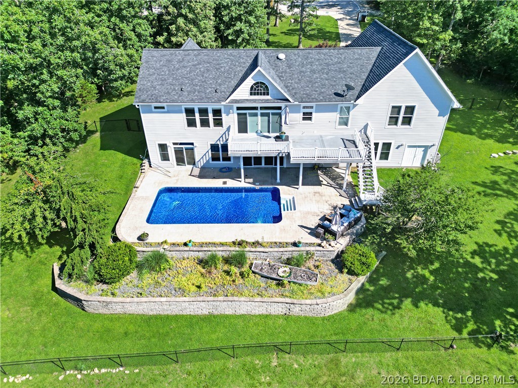 This Four Seasons gem is going to check all of the boxes on your list and is listed below the current appraised value! Located on an interior lake at the end of a cul-de-sac right off Horseshoe Bend Parkway this 5 bedroom, 5 bath home features main level living, vaulted ceilings, a spacious and open floor plan, 4200 sq ft, a private in-ground pool and sits on 1.3 acres offering tons of space to entertain and create long lasting memories for years to come! The oversized main level master suite is perfectly set up with his & hers walk-in closets, a double vanity, a huge walk-in shower & a jet tub. The home also features three Jr. Master suites with full baths as well as a huge family room on the lower level with a full wet bar, workout room, and it walks directly out to the in-ground pool and patio area. Did we mention the large extra room located behind the garage that could be used as a shop or transformed into additional living quarters. This home has it all, and it is perfectly located near some of the best shopping, dining & entertainment the Lake of the Ozarks has to offer! Check out the virtual tour for a bird's eye view of this amazing home!