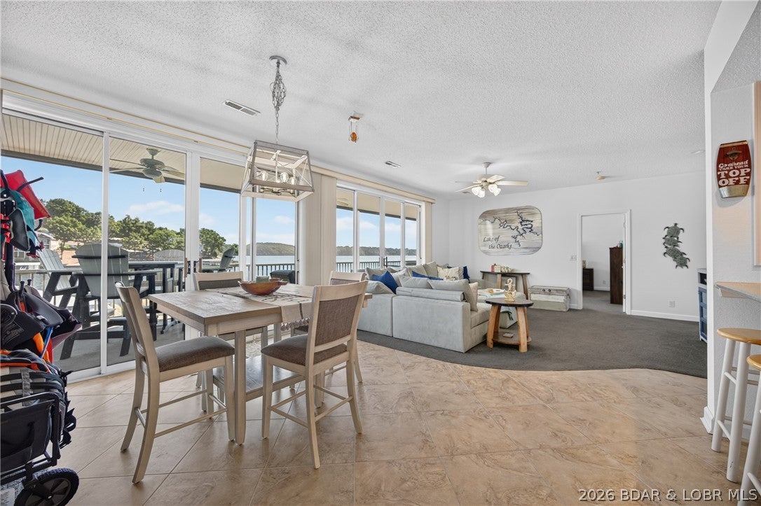 Outstanding location on the POINT- phenomenal views in a highly sought-after complex. Super spacious (1,061 sq ft) 1 bedroom & 1 and 1/2 bathroom condo and over 480 sq ft of deck! ELEVATOR brings you directly to your condo's door! Pool is right there, too! 12x32 boat slip Dock 2 Slip 16 is located right in front of your condo. PWC space and lift available for extra $$. Literally no walking all over the place to get to your slip/pool/jet ski. The oversized water's edge screened-in deck is perfectly situated for Main Channel lake views, watching the boats, listening to the water and east-facing for wonderful mornings and evening tranquility.  Open and spacious floor plan, primary bedroom closet is even large enough for bunk beds. Large kitchen with lakefront dining area. Take a boat ride to Fish & Co., Bear Bottoms or Captain Ron's. The 35 MM is much quieter and is a perfect place to relax and go kayaking. Well-maintained complex features 1 waterfront pool, additional pool & hot tub up on hill for amazing views, tennis, pickleball, and clubhouse with fitness center! Fully furnished and ready for your lake life enjoyment! TRULY A LAKE GEM!