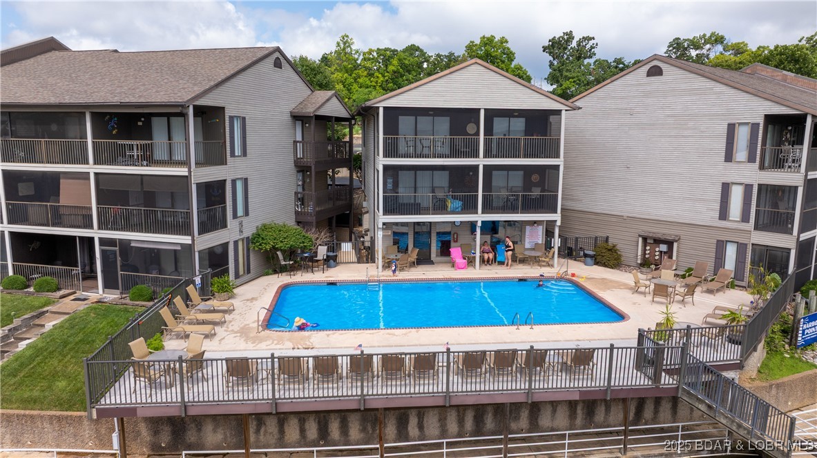 Completely Remodeled, Feels like you are sitting on the water, Walk In Unit. Harbor Point Condominiums! Nestled at the sought-after 21MM of Lake of the Ozarks, this beautifully remodeled 2-bedroom, 2-bathroom end unit offers unparalleled convenience and charm. Boasting walk-in access, this condo features custom cabinets, shiplap accents, high-end appliances, stunning handmade walnut countertops, and a farmhouse sink that ties together the modern yet cozy aesthetic. Fully furnished and turn-key, this property is perfect for a relaxing vacation getaway or a lucrative nightly rental. Step outside to enjoy the community amenities, including a pool, tennis court, and clubhouse. Your private 10x30 boat slip is just steps away, ensuring effortless lake days. Don’t miss the chance to make lifelong memories in this exceptional lakefront condo. Schedule your showing today and see why Harbor Point is the perfect place to call home!