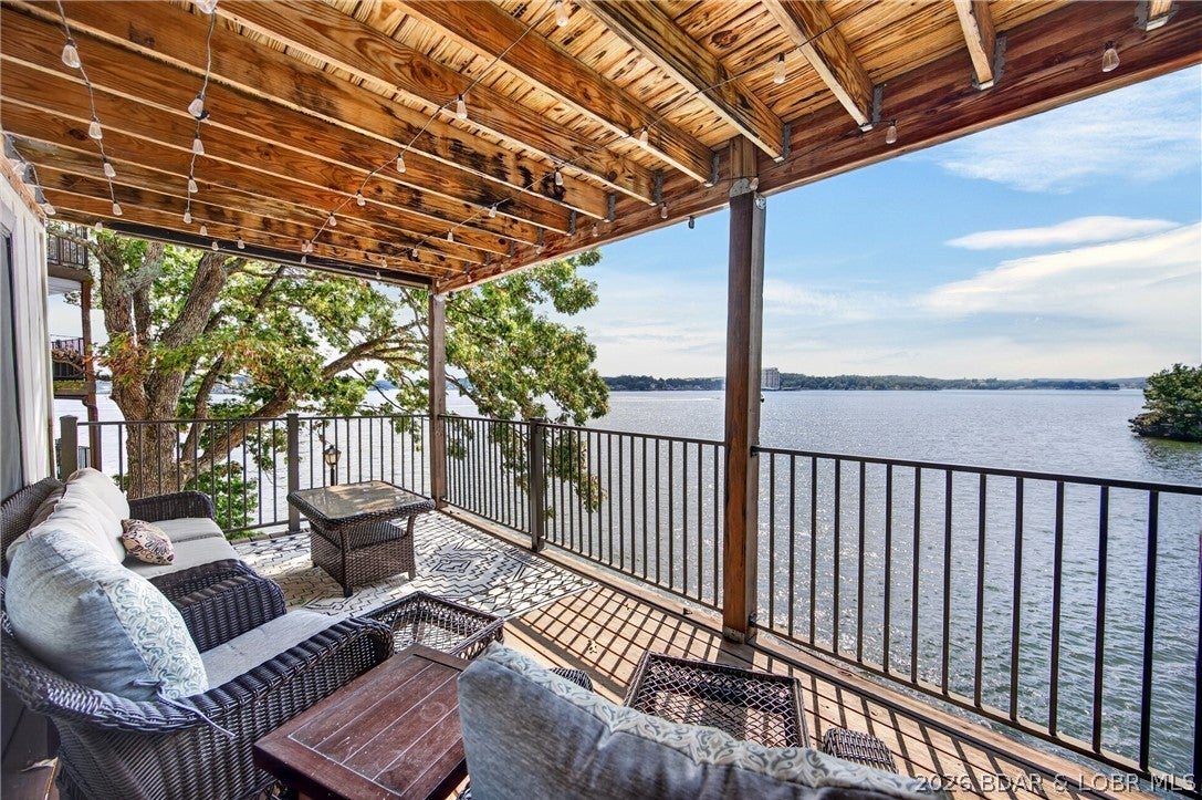 Welcome home to Waters Edge! This beautifully remodeled 3 bedroom, 3 bathroom condo offers unobstructed, sweeping water views — including a rare vantage overlooking the old Bush compound at Lake of the Ozarks. Thoughtfully upgraded throughout with modern finishes and high-end features, this home is move-in ready and being sold fully furnished with tasteful decor. Step out onto the large, expanded deck with new railings, an ideal spot for entertaining or simply soaking in the scenery. A 10x28 boat slip with a 6,000 lb lift means your days on the water start right outside your door. Residents enjoy resort-style amenities, including on-site management and security, a community pool, clubhouse, playground, tennis and pickleball courts, and a well-equipped fitness area — all set within some of the most tranquil grounds at the lake. Take advantage of the waterfront walking and golf cart path, multiple boat ramps, waterfront viewing areas, and lush, mature landscaping. With its prime location on Horseshoe Bend Pkwy, luxurious upgrades, and unbeatable water and golf course views, this condo is a rare find. Schedule your private showing today — your piece of paradise awaits!