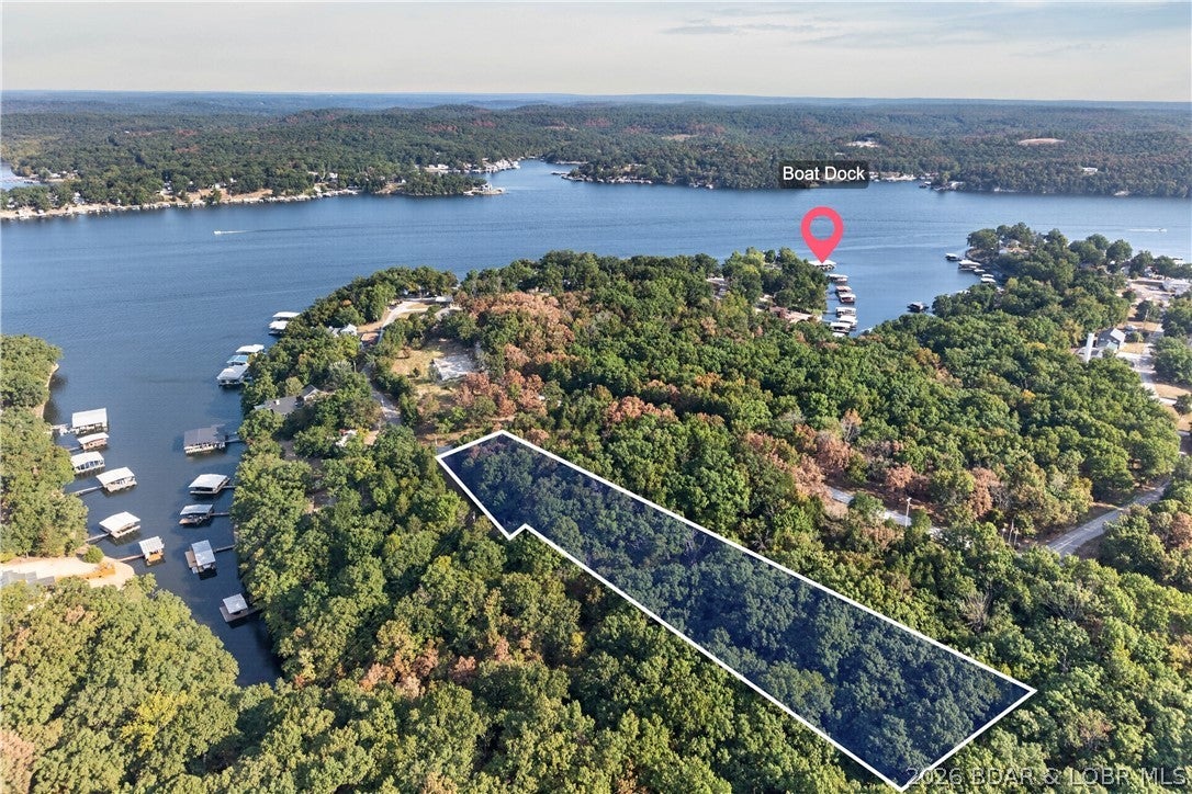 Lake access, acreage AND your own boat slip! This 1.8-acre tract in Sunset Shores is comprised of four lots, offering a very gentle lay with plenty of possibilities for your future lake home or spec build. The property is currently fully wooded with paved roads all the way to the property, subdivision water hookup and fiber optic internet available. Just down the road, enjoy the community boat ramp and dock with your own 12x24 boat slip at the 46 MM of Lake of the Ozarks! Sunset Shores also provides trash service and road maintenance with a 1,200 sq ft minimum building requirement and no nightly rentals. Located just a short drive or boat ride from Boondockz, a local lakeside favorite with a pool. Whether you're ready to build your own lake getaway or looking for your next spec home opportunity, this is an affordable way to secure acreage AND a boat slip at the Lake! Additional 1.4 acres available on the backside! Opportunity to purchase both and have two boat slips!