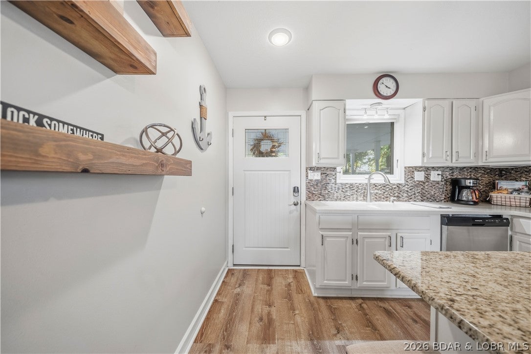 Lakefront living and investment potential meet at this 4-bedroom, 3-bath retreat in Osage Beach, tucked into Backwater Jack’s no-wake cove with panoramic main-channel views. Enjoy excellent water for swimming and boating while being just 0.3 mi from 1932 Reserve and 0.5 mi from Backwater Jack’s. The three-level home has been tastefully updated and is offered fully furnished, providing a turn-key option for personal use or rental investment, with figures showing a 10% return. Four levels of outdoor living include expansive decks and a grandfathered-in martini deck at the water’s edge. The concrete dock features a 32-ft slip, with a dock envelope that may accommodate a larger slip. A zero-step entry adds convenience, while the central Osage Beach location puts dining, shopping and lake activities close by.