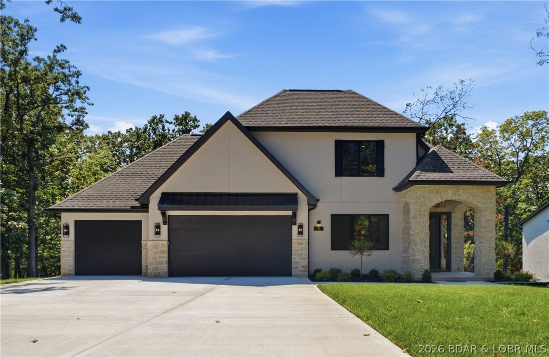 Not all new construction is created equal—and this Porto Cima home proves it. This 3-br, 3-bath, 2,533 sq. ft. home delivers a level of finish/detail you can feel the moment you walk in. Zero-entry, slab construction, flat driveway, main-level living & a 3-car garage make it incredibly functional, while hard-coat stucco, SmartSide, natural stone, concrete decking, buried gutters and a 30-year Timberline roof speak to the quality. Inside, soaring ceilings, solid-core doors, 8" baseboards, designer lighting, wood ceiling accents & a stunning linear fireplace wrapped in porcelain tile create a sophisticated, custom feel. The kitchen features a 9' island, quartz counters & backsplash, GE Profile appliances and induction cooktop, plus a beautiful coffee bar. The primary suite offers a spa-like bath with polished porcelain tile, tiled shower & freestanding tub, plus access to a screened porch and private backyard. Add custom closet systems, attic storage, irrigation, landscaping, blinds, garage shelving and even a 70" TV. Located in Porto Cima, a premier lake community, this is a rare opportunity to own a truly finished home where the quality and craftsmanship separate it from the crowd.