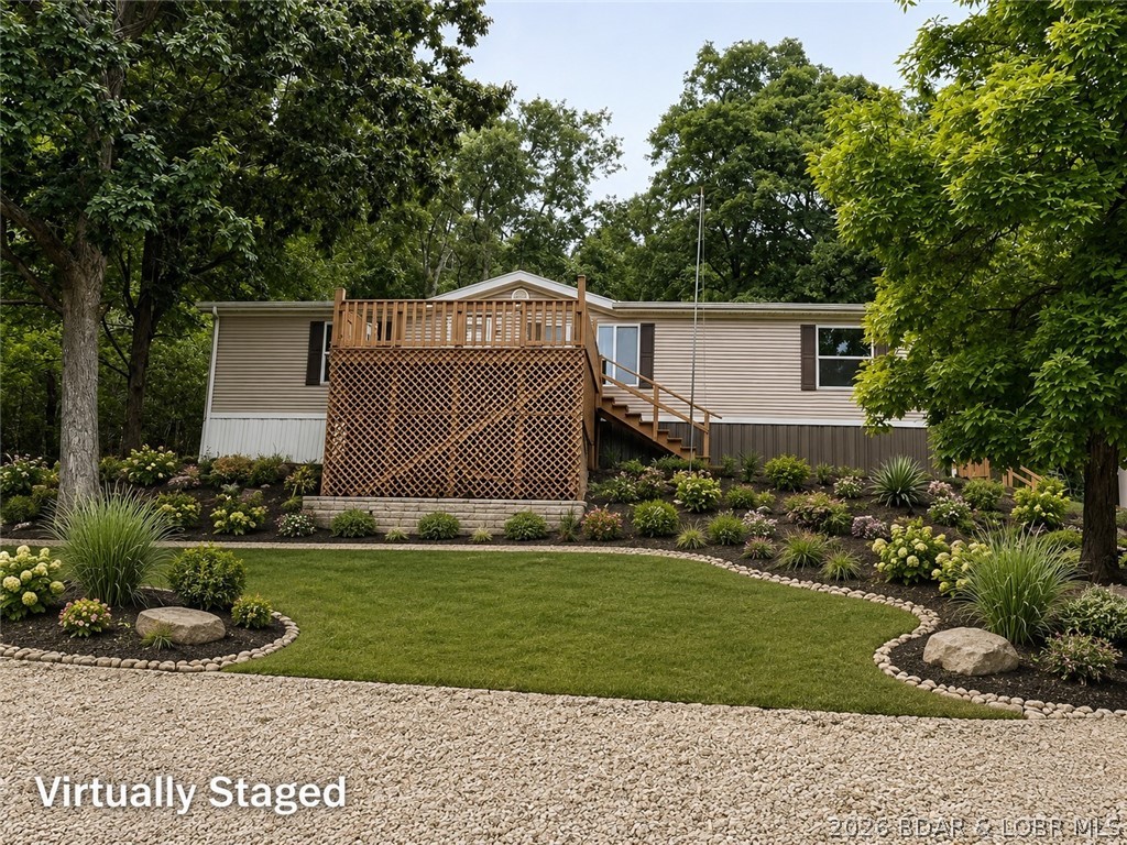 Enjoy beautiful Lake of the Ozarks views and abundant wildlife from this well-maintained 3-bedroom, 2-bath manufactured home on over 3 acres located on the second tier. The home has received numerous updates, including new windows, flooring, decking, kitchen appliances, cabinets, countertops, sink, leaf guard gutters and more.

Tucked away in a semi-private setting, this property offers ample wildlife and peaceful surroundings. Watch deer from the dining room or enjoy convenient access to hunting right outside your back door. With scenic lake views, updated living spaces, and plenty of natural beauty, this home is ideal for a full-time residence or relaxing lake getaway.
Plenty of room to build a garage 
 
Please note: The driveway is steep and may require a four-wheel-drive vehicle during inclement weather.