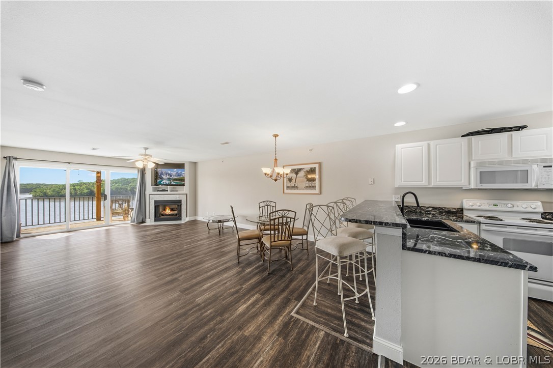 This is the perfect place to make your own.  Located on the quieter Grand Glaize Arm of the Lake of the Ozarks, this 2 br 2 bath condo is just waiting for your special touches.  Soak in the panoramic view of the state park.  NEW flooring/carpet, paint, hotwater heater, dishwasher, granite kitchen counters, sink/faucet.  NEW washer/dryer combo saves space allowing for more storage area.  12x30 boat slip is included.  This complex abounds with green space and is pet friendly.  A community pool with covered areas & ample room for sunning, playground, trailer parking, clubhouse with workout room and kitchen are all complex amenities. Located within the state park where there are trails to hike & bike, a beach & boat launch is where you'll find your new lake escape.  Crappie, bass & catfish are caught right off of the docks.  This is the perfect area for boating, wakeboarding or just coving out as it is surrounded by gorgeous state park views.  Only 10 miles back to Osage Beach Pkwy where restaurants and stores are found.  By water, you are an easy boat ride to Dog Days, Backwater Jacks, Shorty Pants & Redhead Yacht Club.  Stop the search, here it is-Dreams to Reality!  Call today!