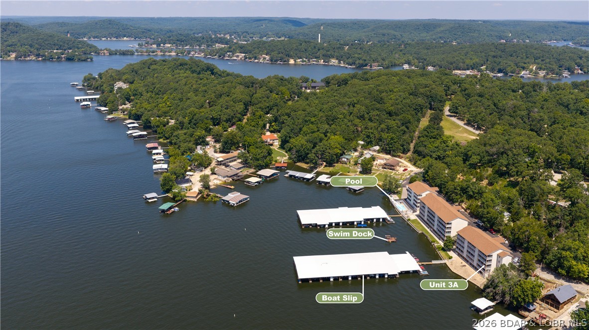 Rare opportunity! Sportsmans Harbor is 1 of the Lake of the Ozarks' best-kept secrets, with only 35 units and just 3 MLS listings in the past 10 yrs. Updated in 2023, this Walk-In 3BR/2BA condo is professionally decorated and offered completely turnkey, including all furnishings and a boat lift. The enclosed lakeside deck showcases not only Million-Dollar views of the Lake but also sunrises and sunsets, and adds valuable living space year-round. Open the large panel windows to bring in the fresh lake breeze. Includes a 34' boat slip with lift, community pool, swim dock with diving platform and some of the lake's lowest HOA dues only $276/month. Located at the 1 MM of the Little Niangua Arm you'll enjoy calmer water, outstanding fishing and a peaceful family-friendly setting without the heavy traffic of the Main Channel. Only minutes by boat to The Cave, Fish & Co., NautiFish Rum Bar and Ha Ha Tonka State Park. By car Camdenton and Sunrise Beach are nearby for shopping, dining, healthcare & everyday amenities. This move-in ready Lake Retreat offers the perfect blend of comfort, convenience, boating and unforgettable views. Just bring your swimsuit to start living the Lake life!!!