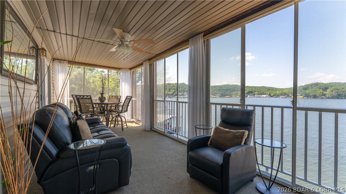 Rare opportunity! Sportsmans Harbor is one of the Lake of the Ozarks' best-kept secrets, with only 35 units and just 3 MLS listings in the past 10 yrs. Updated in 2023, this Walk-In 3BR/2BA condo is professionally decorated and offered completely turnkey, including all furnishings and a boat lift. The enclosed lakeside deck showcases not only Million-Dollar views of the Lake but also sunrises and sunsets, and adds valuable living space year-round. Open the large panel windows to bring in the fresh lake breeze. Includes a 34' boat slip with lift, community pool, swim dock with diving platform and some of the lake's lowest HOA dues only $276/month. Located at the 1 MM of the Little Niangua Arm you'll enjoy calmer water, outstanding fishing and a peaceful family-friendly setting without the heavy traffic of the Main Channel. Only minutes by boat to The Cave, Fish & Co., NautiFish Rum Bar and Ha Ha Tonka State Park. By car Camdenton and Sunrise Beach are nearby for shopping, dining, healthcare & everyday amenities. This move-in-ready Lake Retreat offers the perfect blend of comfort, convenience, boating and unforgettable views. Just bring your swimsuit to start living the Lake life!