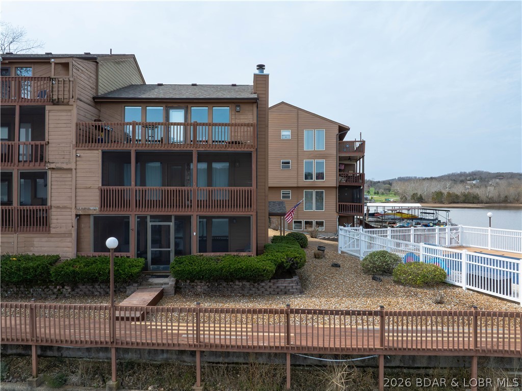 ONE OF THE LARGEST ONE BEDROOM CONDOS CURRENTLY ON THE MARKET! This walk-in unit offers minimal concrete steps into your unit with direct access to the lakefront pool and lakefront boardwalk & docks! Welcome to Lake Valley Condominiums located at the 13 mile marker of the Big Niangua at Lake of the Ozarks. This oversized one bedroom/one bathroom lakefront condo comes turn-key, offers over 800sq ft of open concept living space and also comes with a 10x20 boat slip, dock locker and a 4,500lb boat lift. You will love the direct access from your front door and private screened-in patio to the outdoor pool and lakefront boardwalk. This unit offers a stone wood-burning fireplace, granite countertops and LG stainless appliances. The Big Niangua is known for great fishing-so you will certainly enjoy having access to the fish cleaning station on the community dock. Come take a peek for yourself and fall in love with this peaceful complex on quiet waters! With only about 42 units total, the complex offers a serene environment. USPS private mailbox is included at no additional charge at the complex! THE DECK SPECIAL ASSESSMENT HAS BEEN PAID IN FULL BY SELLERS ALREADY!