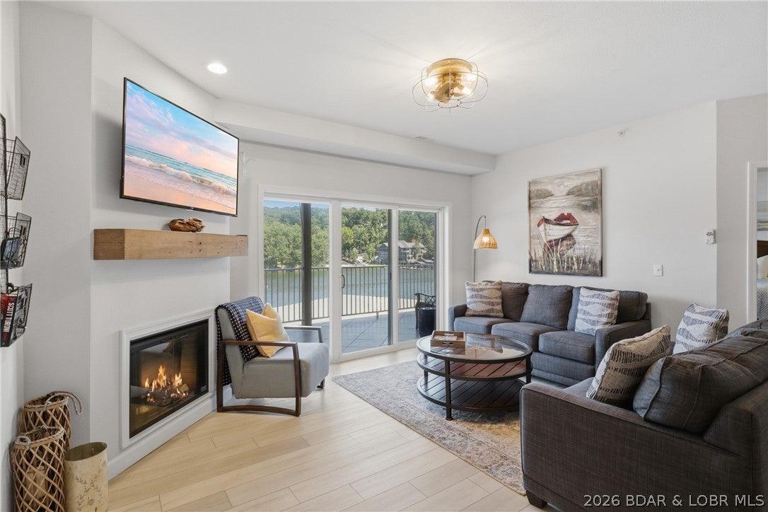 Lake life starts here at Lochhaven! This stylish, updated 3BR/2BA lakefront end-unit condo pairs luxury finishes with the space, views and waterfront setup buyers want at Lake of the Ozarks. Step inside to a bright, open floor plan with wide-plank LVP, custom cabinetry, updated countertops, stainless kitchen appliances and an inviting electric fireplace. Offered turnkey with furnishings, kitchen appliances, washer and dryer included, so you can arrive and start enjoying the lake from day one. The huge tiled deck extends your living space outdoors with water views and room to relax and entertain. Boaters will love the 12x32 slip plus PWC slip with PWC lift included. Nightly rentals are allowed, creating an excellent opportunity for vacation rental income, a second home, or both. Located in a great cove at the 31 MM with easy access to popular lake destinations and excellent water for coving out. This one-level end unit is close to the elevators and offers 1,352 sq ft, 3 bedrooms and 2 full baths. Lochhaven also offers a community pool, boat trailer parking and community docks. Your stylish lake escape is ready—bring your bags and start making memories at Lake of the Ozarks today!!!!