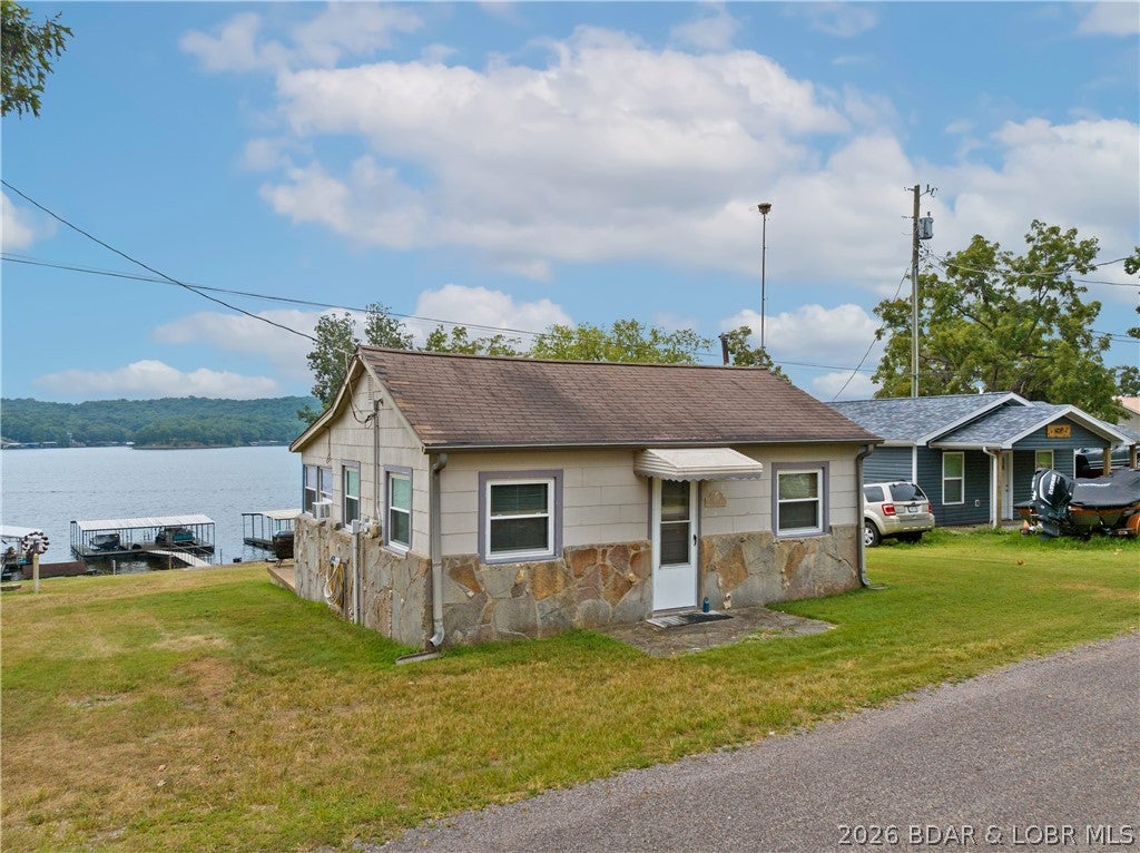 Lake Front Cabin with 2-Well Dock, Boat Hoist and great Lake View.  Lake Home comes TURNKEY.  The Living Room has Lake View Windows and easy walk to the Dock.  There is an Eat-In Kitchen with Ceiling pull down Storage.  Bathroom has Laminate Flooring and Walk-In Shower.  The Laundry has a stackable Washer/Dryer.  New Windows, Plumbing and Electric Heat have been  installed.  There is a Concrete Patio on Lake side of Home for outdoor entertaining.  Great Lake Home to enjoy the Lake that has deep water and a Sand Beach.  Close to Big Dick's Halfway In Lake Restaurant.