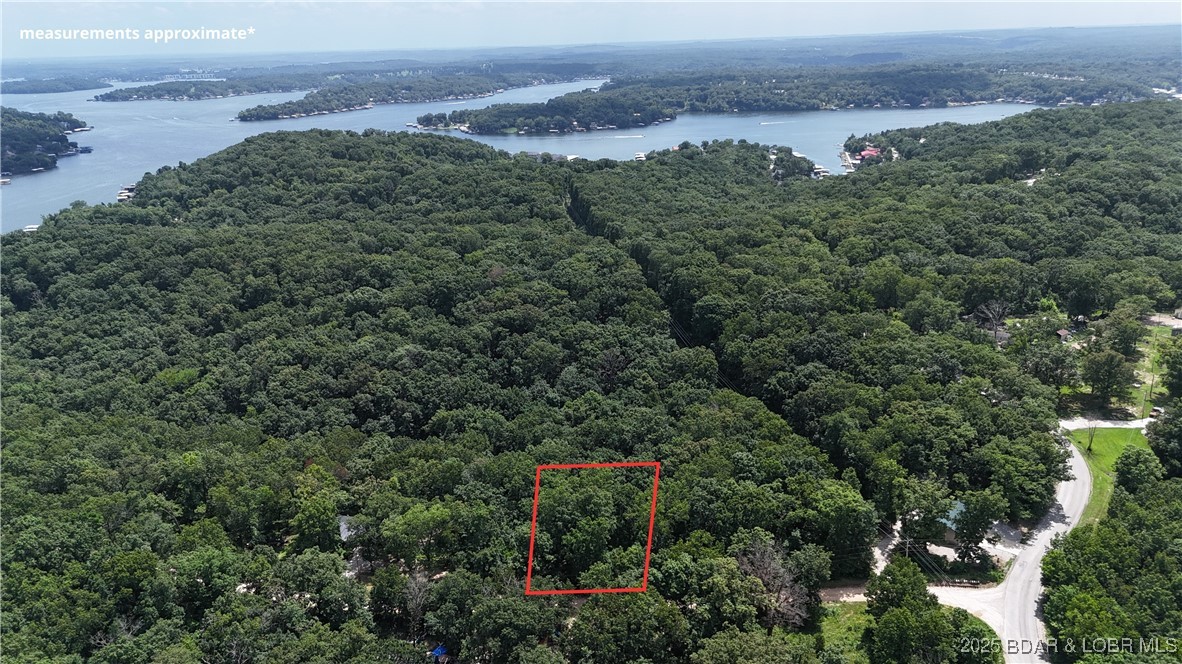 Lucky Point Subdivision, Rocky Mount. .21 Acre Wooded Lot – Unrestricted – Looking for a peaceful slice of the Lake of the Ozarks? This .21-acre wooded lot in Morgan County could be your perfect getaway! Offering you the freedom to park your RV, build a shouse, or design your dream lake retreat. Property Features: Gently to moderately sloped, wooded lot with a beautiful mix of mature trees. Just a short drive off pavement – easy access, yet tucked away. Unrestricted – build what suits your lifestyle. Enjoy the community boat ramp and swim beach (optional membership for a small annual fee). Coffman Beach Public free boat ramp, near by. Convenient location – minutes from Jolly Roger’s and all the action of the Northshore. Short drive to Bagnell Dam! Whether you're seeking a weekend camping spot or a long-term investment near the lake, this lot offers peace, potential, and proximity to Lake of the Ozarks fun.  Come see the natural beauty and opportunity this property offers!