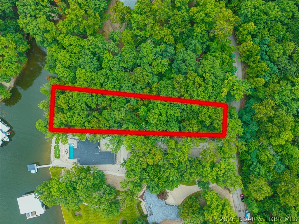 Embrace the ultimate lakefront lifestyle at Porto Cima on this premier 0.64-acre lot, beautifully nestled within a serene canopy of mature trees. This exceptional property offers the perfect private canvas for a custom build, with the POA requiring a home of at least 1,500 square feet or equivalent to the high architectural standards of the surrounding estates. Ownership includes access to top-tier neighborhood benefits, featuring community pools, a modern exercise room, tennis and pickleball courts, and full access to the sought-after Four Seasons amenities. For the ultimate country club lifestyle, optional Porto Cima Clubhouse memberships are available for an additional fee, granting elite access to golf courses, and upscale dining. A clean canvas, mature timber, and endless luxury await your vision.