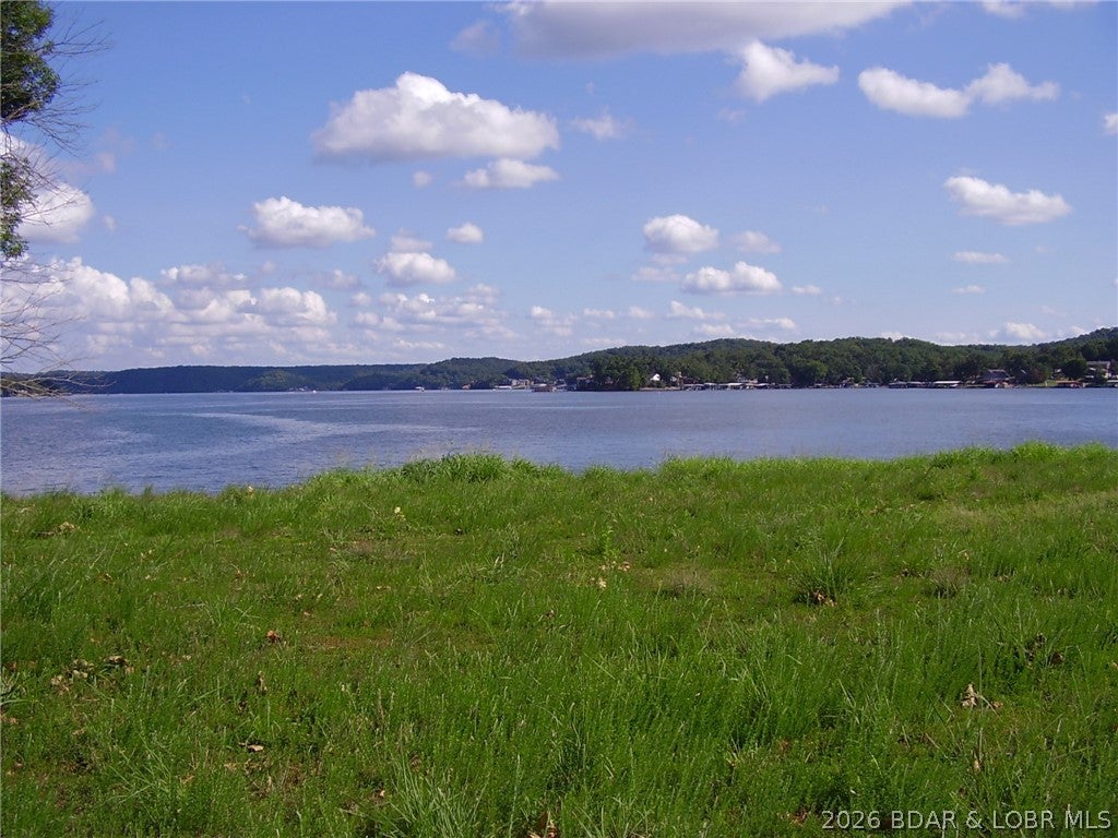 Welcome to Kamden Estates, an exclusive new development on a picturesque point at the 44MM of Lake of the Ozarks. Presenting Lot 3—an exceptional opportunity to own a prime piece of lakefront. This lot features approximately 249ft of pristine lakefront and w/.44acre. The land has been improved to elevate from the floodplain and a seawall is already in place. The community will feature on-site sewer treatment and community water services. While connection fees for utilities are still to be determined, this lot offers an incredible foundation for your dream home, with a minimum build requirement of 3,000+ square feet. What sets Camden Estate apart is its remarkably flat terrain, allowing you to build just steps from the water’s edge—perfect for those who want to live the ultimate lakeside lifestyle. Enjoy calmer waters ideal for swimming and boating, while still being close to popular local spots like Boondocks and Bear Bottoms. Don’t miss your chance to be part of this exclusive community. Lot 3 at Kamden Estates is where your vision of luxurious lakeside living becomes reality.