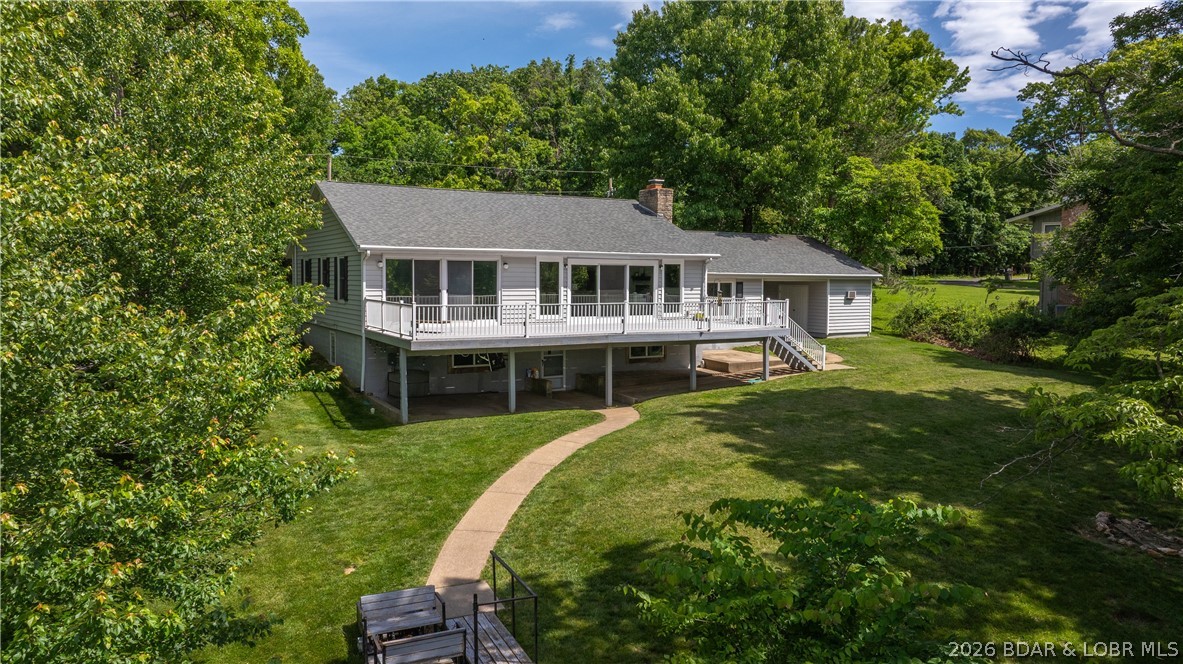 Lakefront living at its finest! This updated 4-bedroom, 3-bath home sits on a rare 1-acre lakefront lot at the 17MM of the Osage Arm, offering privacy, space, and elevated water views. The two-well dock features a swim platform, waterslide, and two PWC lifts—perfect for enjoying endless days on the lake. Multiple expansive deck and patio areas provide ideal spaces for entertaining or relaxing while taking in the scenery. Inside, you’ll find updated finishes, an open and inviting layout, and generous living areas designed to comfortably accommodate family and guests. The lower level adds additional recreation and gathering space, making this home well-suited for hosting or maximizing rental potential. This property truly move-in ready. A recent appraisal is available for added buyer confidence and peace of mind. Located just minutes from the Bagnell Dam Strip, you’ll enjoy quick access to restaurants, shopping, and nightlife while maintaining a private lakefront setting. Whether you’re seeking a full-time residence, vacation retreat, or income-producing investment, this property delivers the best of Lake of the Ozarks living. Schedule your showing today!