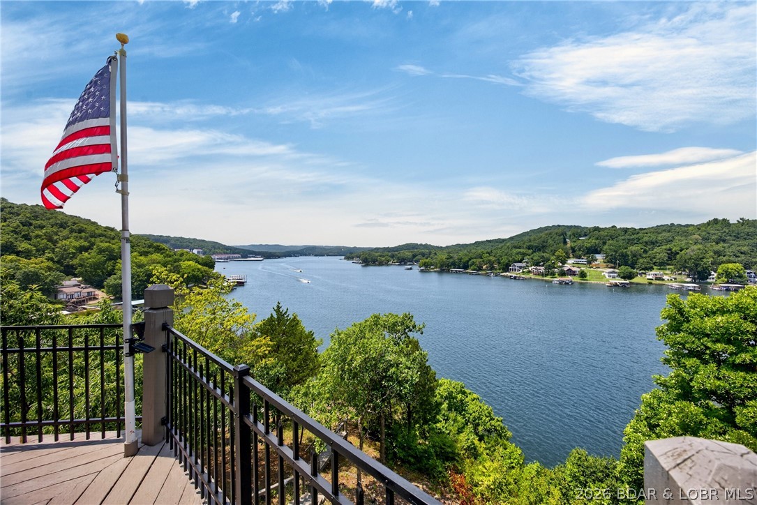 Near Camdenton: “HARD-TO-FIND” Spacious Fabulous Lake Home offering Wooded SECLUSION from Neighbors, FABULOUS Bird's Eye LAKE VIEW, 1½ AC w/526Ft of LAKEFRONT, QUIETER ‘DEEP’ WATER. Many Updates. 3935SqFt, 5Beds w/Lake Views (Including Apt above Attached 2 Car Garg) 5 Baths, Priv Beach+Your Own Paved Park’g Lot for 4-6cars & Easy Delivery of Lrg Items to Dock/Beach. Awesome Concrete/Steel Dock w/2Boat Slips, Dbl PWC Slip, Swim Dock, 1Boat Lift +1Dbl PWC Lift @ 9Mile Marker of Big Niangua. Be WOWED w/Million $ Lake Views upon stepp’g in Frt Door. Enjoy Sunset Views, Watch Eagles Soar & Storms roll-in. Great FlrPlan w/2 ½Levels of Liv’g. 2Levels Wrap Around Lakefront Decks. Partly Furnished. Main Level Liv’g. LvRm Boast impressive “CYPRUS WOOD” Cathedral Ceiling, Wood Floors, Fireplc & Walls-of-Windows. 2Mast Bedrms (1w/Fireplc), 3Kitch Areas, Fabulous Main Kitch offers Newer SS Appliances, Granite Counters, Abundance of Custom Cabinetry, Builtin Kitch Desk, Kitch Island. Spacious Floorplan also includes FamRm, Wet Bar, 4Seasons Rm. Lots of Park’g. Newer Roof, HVAC, Security System, H20 Heater & Softener, Toilets, 65” Jetted Tub +so much; Must See EXTRA FEATURE SHEET for more Details