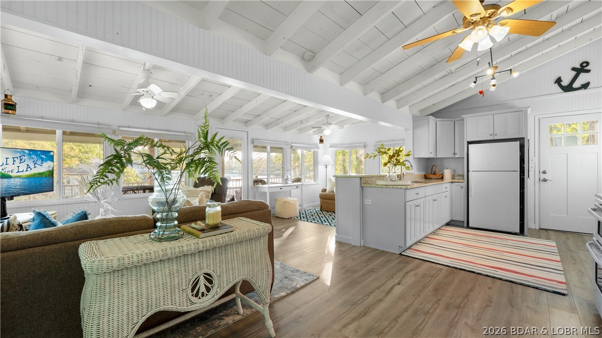 This Cape Cod cottage offers the quintessential lake escape. Light-filled & beautifully updated, this home lives bigger than it looks with a spacious new kitchen including granite counters & custom cabinetry with vaulted ceilings that extend seamlessly into the primary bedroom, a new full bath, and new deck that wraps the the home lakefront. The lot is incredibly gentle and has a great grassy lakefront yard with a bonfire pit. At the water's edge you’ll find a single-well dock with hoist, plus a lakefront boathouse and martini deck. The boathouse has real potential to be transformed into additional living space or enhanced lakefront value. Located at the 43 MM, this property offers paved roads to the door, easy access to and from the lake, with a community boat ramp just 3 homes away. 2nd tier property directly behind the home is available for purchase. It’s rare to find this combination of such a quality lakefront home at this price point that’s move-in ready.