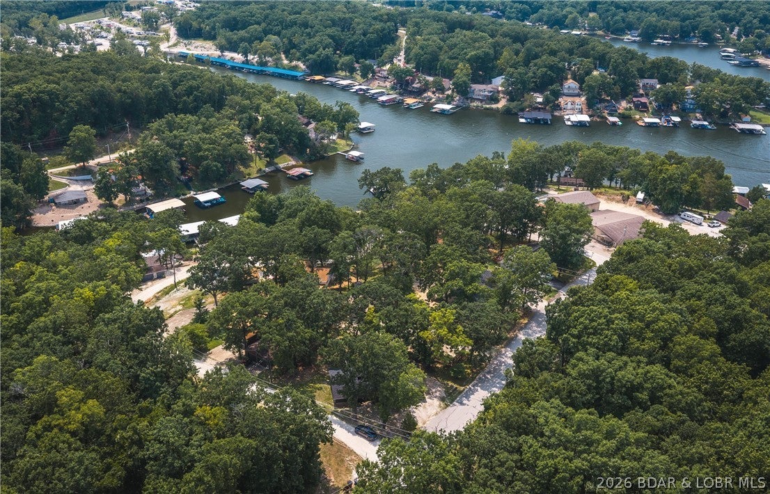 Escape to the Lake of the Ozarks lifestyle with this charming 3-bed, 1-bath single-level home in the heart of Sunrise Beach. Whether you're searching for a full-time residence, weekend retreat, or investment opportunity, this inviting property offers comfort, convenience & easy access to the water. With no HOA or restrictions, you'll enjoy the freedom to make the property your own while taking advantage of the included 9x20 boat slip at the nearby community dock. Inside, the welcoming living room is filled with character, featuring a cozy fireplace & a vaulted ceiling accented by beautiful wood beams that create a warm, lodge-inspired atmosphere. The functional single-level floor plan makes everyday living easy, while the attached one-car garage provides additional storage and convenience. Step outside onto the brand-new back deck, the perfect place to enjoy your morning coffee, entertain friends, or unwind after a day on the lake. A roof replacement in 2023 adds valuable peace of mind for years to come. Don't miss this opportunity to own an affordable Lake of the Ozarks getaway with a boat slip included. Schedule your private showing today and start making memories on the water!