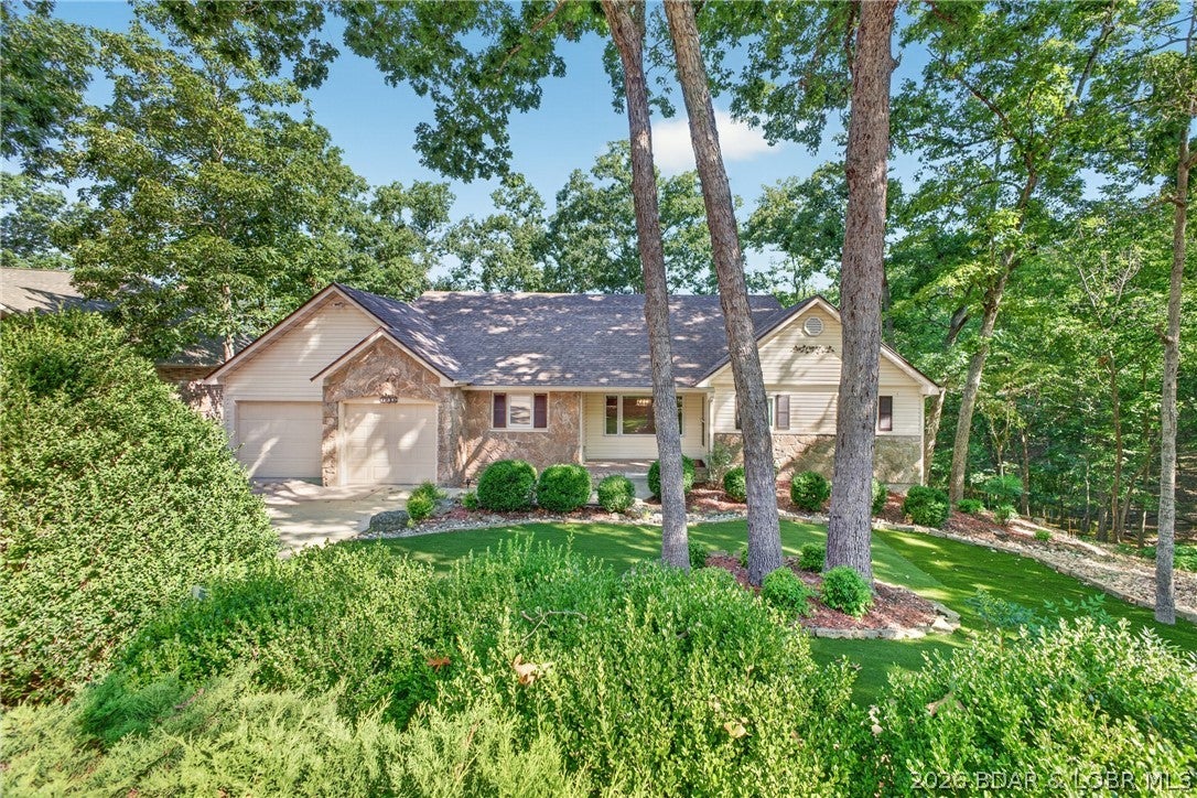 Serene cove setting in established neighborhood. Well constructed 4 bedroom home features main level living, walk out lower level large decks and a gentle walk to your dock. Enjoy your morning coffee in the lakeside sunroom w floor to ceiling windows overlooking the peaceful wooded cove setting, you may catch a glimpse of a Blue Heron hunting his breakfast or deer's in the greenbelt across the cove. The spacious main level suite walks out to lakeside deck thru new Pella patio doors, two walk in closets. Private bath with tub and walk in shower also has heated floors. Lower level with three large bedrooms and shared hall bath with heated floors. The family room with wet bar  has room for game table  and a big screen TV, The room opens to large lakeside deck and patio just a few steps from the Lake. A bonus room private space for a home office or craft room. Great location and good bones, this well maintained home is ready for the right person to see the potential and make it their home.