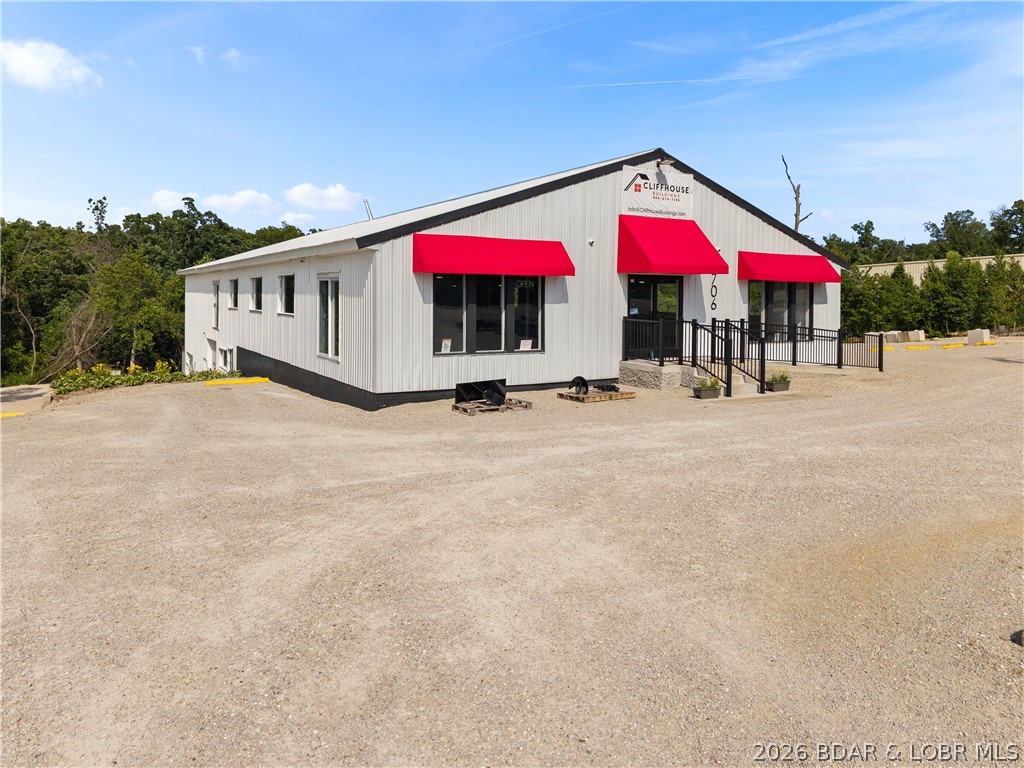 Exceptional commercial opportunity with outstanding visibility and endless potential! This 12,000 sq. ft. property sits on two commercially zoned lots and offers a versatile layout ideal for retail, office, showroom, warehouse, or light industrial use. The upper 6,000 sq. ft. level features spacious showroom and office space with a private entrance, storefront windows, overhead door access, and plumbing for a full bath. The lower 6,000 sq. ft. level includes two overhead doors, walk-out access, ample storage and workspace, plus plumbing for a half bath.

Extensively updated and move-in ready, improvements include fresh paint, ADA-compliant accessibility upgrades, updated restrooms, LED lighting, ceiling fans, commercial entry doors, and a new elastomeric roof coating completed in 2024. Additional upgrades include refreshed siding, awnings, and a high-efficiency mini-split HVAC system installed in 2025, plus two furnace systems for backup heat. Security features include a 16-camera wired system with color night vision and audio. Complete with ample parking, professional landscaping, a prominent 8'x12' sign, and completed survey. Turnkey and ready for immediate occupancy!