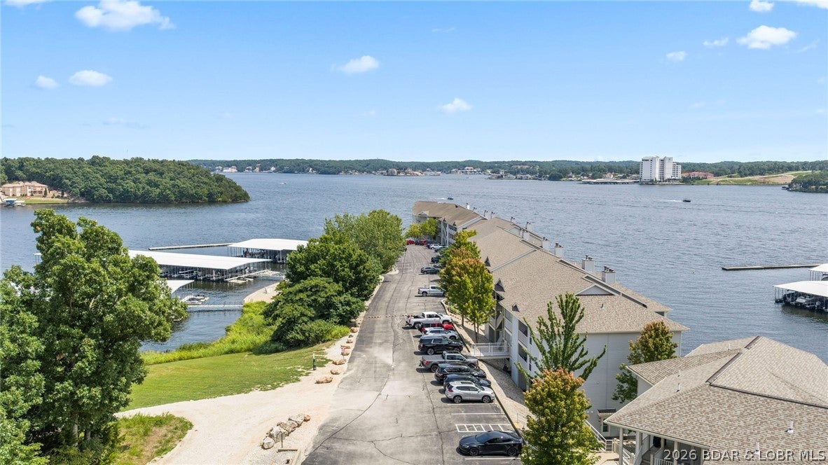 Furnished and ready for lake life at Regatta Bay! This 2-bedroom, 2-bath end-unit condo offers an open kitchen and living area that flows directly onto a screened deck with vinyl enclosures for extended seasonal enjoyment. Located just one flight down from parking, the lower-level unit also includes convenient exterior storage and a 12x32 boat slip with lift.
Regatta Bay offers an impressive lineup of amenities, including two community pools, clubhouse, tennis and pickleball courts, a playground area, and more. Short-term rentals are allowed, providing flexibility for buyers looking for a personal lake retreat, investment property, or a combination of both. Centrally located at the Lake of the Ozarks, you’ll also have convenient access to popular dining, entertainment, and attractions both by road and water. With furnishings, boat slip, and a lift included, this condo offers an easy opportunity to start enjoying Lake of the Ozarks.