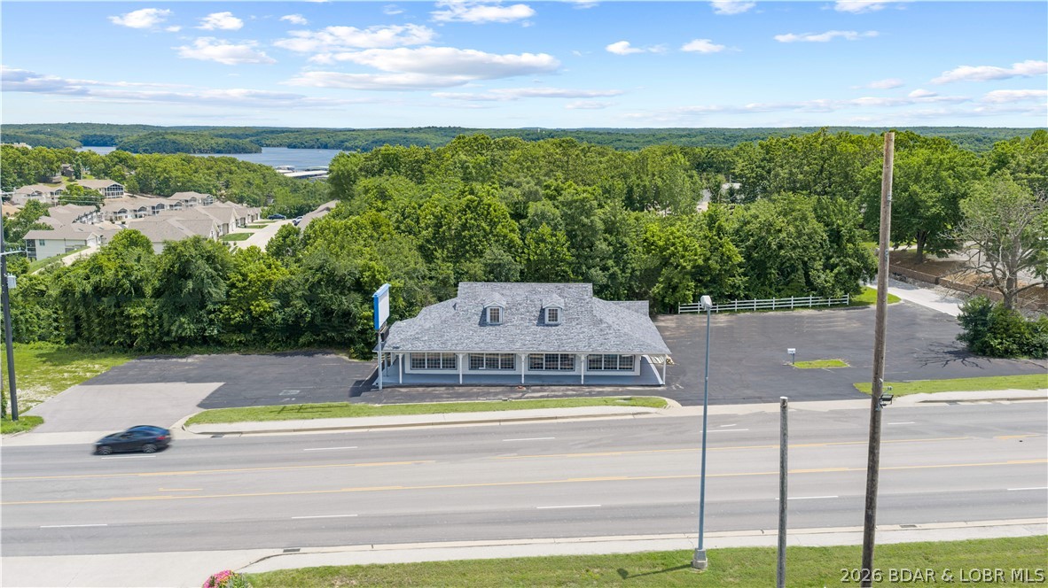 Located in the heart of bustling Osage Beach and off of Hwy 54 this property offers unparalleled exposure and accessibility. Benefit from high traffic counts and excellent visibility in a popular tourist destination and growing community. This versatile building can be configured to suit various business needs, with the option to subdivide into three distinct units. Design it to be one large retail, 3 small businesses, or two businesses in the upper level and an apartment downstairs supporting 3 streams of revenue. This flexibility is ideal for a growing business or multiple tenants seeking prominent retail space.  Rebuilt in 2000, HVAC's replaced in 2025, and a new roof in 2024, makes this building move in ready. A large parking lot provides plenty of space for customers and employees, a significant advantage in a commercial setting. With the Oasis Amusement park, the fisherman's Resort Lodge, and other businesses moving into the area, this is a fantastic location to capitalize in a thriving commercial district. Easement in the back of the building can support an addition for more office spaces. The opportunities are endless on this property. See it today, this one won't last.