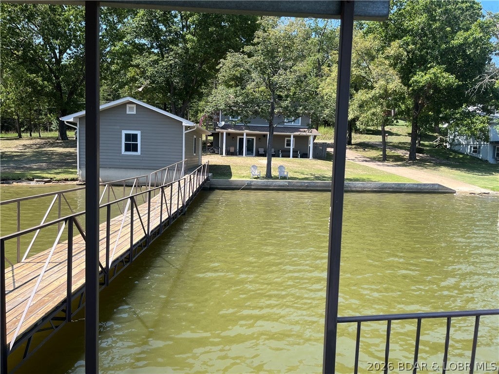 Great lake front house with 3 bedrooms and 2 bathrooms. Flat lot with 250 Feet ft. of lake front.
Two car garage with workshop inside. (tools stay)  Great for all those lake toys and furniture.
Two well dock with a swim dock with picnic table and a PWC drive up lift. Nice swim ladder attached to the dock.
This home comes furnished and ready for your family fun. Private boat ramp to enjoy all your lake toys,
Two extra lots for privacy giving you 250 ft of lake front and room to build on or another home. 2009 Kubota 2660 Diesel with mower and bucket lift available for $6,000 (list for $8,000)