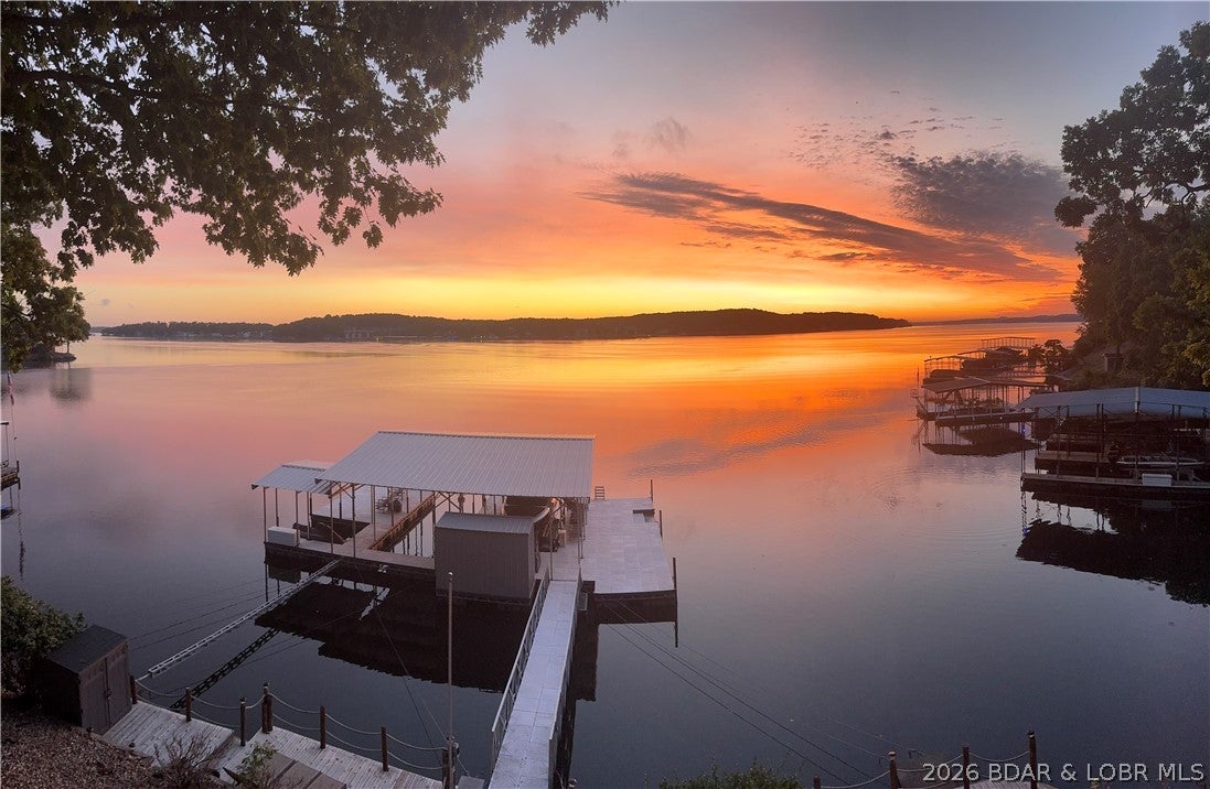 Welcome to lake living at its finest! This beautifully maintained 3-bedroom, 3-bath home offers everything you need to enjoy the Lake of the Ozarks lifestyle. Step outside to an expansive newer concrete dock featuring two boat slips, two PWC slips and one EZ Dock lift, convenient swim steps, and plenty of space to relax, entertain, or soak up the sun. Designed to embrace outdoor living, the home offers multiple decks, including a charming martini deck—the perfect spot to unwind while taking in the lake views. A concrete circle drive provides ample parking and easy access for family and guests. Inside, the thoughtful floor plan offers comfortable accommodations for everyone. The lower level features two guest bedrooms, each with its own private vanity and sink, while sharing a full bath—providing added convenience and privacy for family and visitors alike.
Whether you're looking for a full-time residence, weekend getaway, or investment opportunity, this lakefront retreat combines comfort, functionality, and exceptional waterfront amenities in one package.
