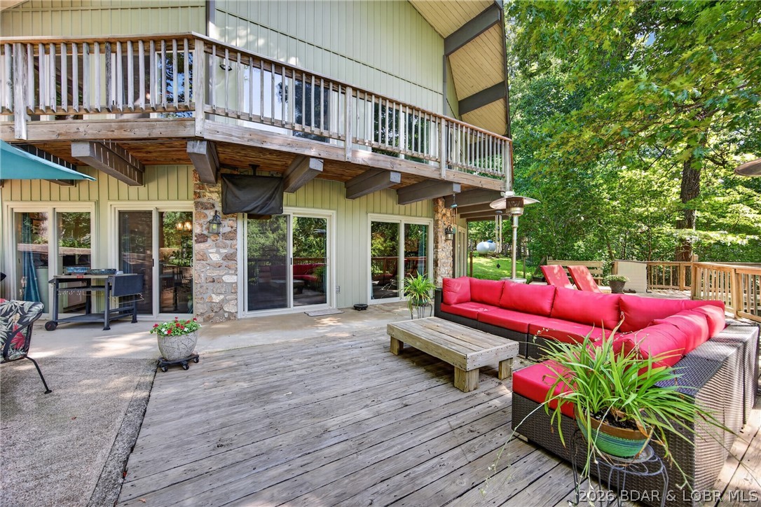 Experience the best of Lake of the Ozarks in this beautifully updated, turn-key home in Gravois Mills. Offering lake access, a boat slip in the community dock, and just minutes from shopping and popular lakefront restaurants by land or water, this home is ready for you to enjoy. Pride of ownership shines throughout, from the welcoming front patio and fire pit to the open-concept living, dining, and kitchen featuring wood beams, wood floors, granite countertops, a large island, and spacious bedrooms. The primary suite includes a loft, perfect for a reading nook, home office, or extra sleeping space. Relax on the expansive back deck or upper deck overlooking the peaceful cove. The oversized garage is heated and cooled with a mini-split system, includes an EV charger, and offers plenty of room for vehicles, golf carts, and lake toys. A whole-house generator provides added peace of mind, and a golf cart path makes the short trip to the dock quick and easy. Being sold fully furnished, this exceptional home is move-in ready—just bring your suitcase and start enjoying the lake lifestyle!