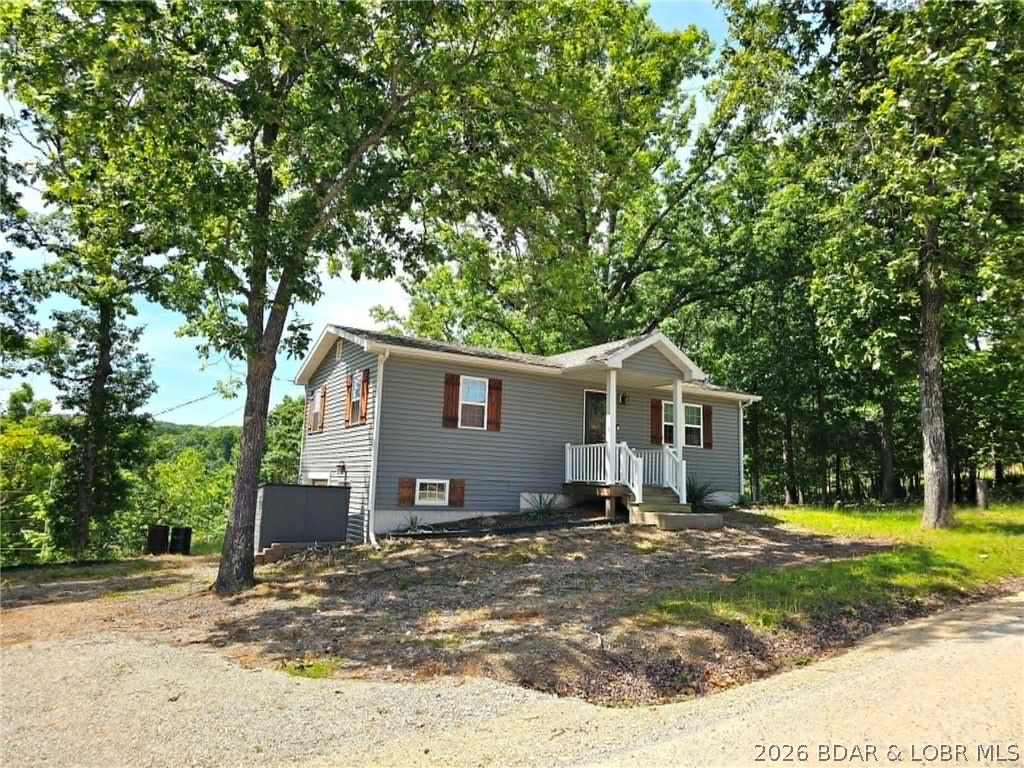 A FISHING ENTHUSIATST'S DREAM RETREAT.........This second tier 2 bed, 1 bath home offers incredible potential—easily convert it into a 3 bed, 2 bath by finishing the basement and adding instant value. Just a quick half-mile drive to the community dock in a calm wide cove you will find your private 10x20 boat slip and dock locker. Want to take in the views, jump in the lake or soak up the sun? Located next to the community dock there is a martini deck overlooking a swim dock—perfect for relaxing or spending the day on the water with family. Situated on +/- .7 acres, this property offers ample room for kids and pets to roam, with plenty of space to add a garage, play area, or other outdoor amenities. Just minutes from town, you’ll have easy access to groceries, popular lakeside bars, and local restaurants. Whether you're looking for a weekend retreat or a full-time lake getaway, this is an affordable opportunity you don’t want to miss. Nightly rentals are allowed if you are wanting an investment opportunity. Schedule your private showing today and start living the lake life!