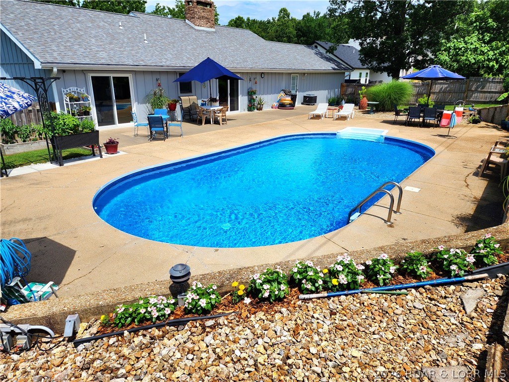 Motivated seller! This private oasis is in the heart of Camdenton. 3 bedrooms, 2 full baths, 1,503 sq ft of 1-level living. Hardwood floors & newer custom-built wood cabinets in living room & see-thru brick gas fireplace. Spacious kitchen with large Laundry/Mud Room & pantry areas. Home is meticulously maintained & displays pride of ownership. Within 1-5 minutes to schools, restaurants, shopping, healthcare & Lake activities. Gorgeous inground saltwater pool w/ privacy fence & landscaping. Pool goes from 3 to 6 ft deep w/ new liner, filter, & pump in 2024-2025. Patio wired for hot tub! Electric water fountain, strawberries, asparagus, herbs, & perennials make this a peaceful retreat. 24x24 Attached 2-car garage w/lots of storage area in the loft & chair lift into home. 4’ tall crawlspace w/ Vapor Barrier. Detached Storage Building for even MORE storage! Large breezy covered front porch overlooks the neighborhood & yard. Spacious Driveway will accommodate 6 additional cars. Move-in ready. Friendly, quiet, shady neighborhood w/NO HOA. Whole-home H20 filter system, water softener (owned), inground sprinkler system, monitored security system. See EXTRA FEATURE SHEET for more details.