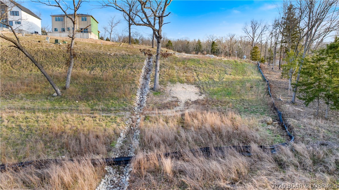 Welcome to Harpers Cov—Osage Beach’s newest lakefront and lakeview/lake-access subdivision, ideally located at the 18 Mile Marker of the Osage Arm. Positioned by both land and water, you’re only minutes from the best dining, entertainment, and attractions the Lake of the Ozarks has to offer. This exciting new community is gaining strong momentum, with beautiful new construction homes, villas, and homeowners already enjoying the Harpers Cov lifestyle. Residents enjoy exceptional amenities including a lakeside pool and clubhouse, paved streets with curbs and sidewalks, fiber optic internet, natural gas, city water and sewer, community trash service, and street lighting. Explore the community park area by the iconic Elephant Rocks—a truly unique feature that sets this neighborhood apart. The development is golf cart friendly, with paths leading to the community pool and docks, with additional docks planned for the future. Numerous boat slip sizes are available & PWC Spots. Now is the time to build your custom lake home in one of the most centrally located communities at the Lake of the Ozarks. Builders welcome. Each buyer contributes $1,500 to the subdivision reserve fund at closing.