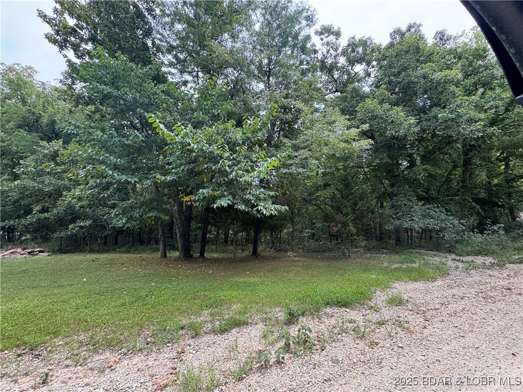 Discover 6.94 acres of beautiful wooded land in the heart of the Lake of the Ozarks area, ideally located just minutes from Laurie, Sunrise Beach, and Versailles. Enjoy the privacy of a secluded setting with the convenience of being within walking distance of the lake.

Whether you're ready to build your dream home, create the perfect weekend getaway, hunt, camp, hike, or simply enjoy the outdoors, this versatile property offers endless possibilities. With no HOA, you'll have the freedom to use the land your way.

Public lake access, a boat ramp, and boat slip rentals are all less than 10 minutes away, making it easy to enjoy everything the Lake of the Ozarks has to offer. Buyer to verify the availability of all utilities.