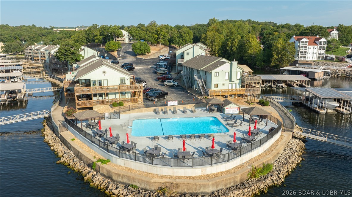Escape to the stunning Lake of the Ozarks with this charming one-bedroom, one-bath condo at Southwood Shores, where relaxation meets exceptional investment potential. Recently updated with a stylish new backsplash, smart TVs, modern fixtures, and thoughtful finishing touches, this move-in-ready retreat is perfect for personal enjoyment or as a rental opportunity. The community is designed for year-round fun, featuring an indoor pool with a hot tub, a lakefront outdoor pool, a spacious swim platform with direct lake access, a playground, tennis and basketball courts, and a scenic waterfront boardwalk ideal for leisurely strolls or fishing. Whether you’re seeking a peaceful getaway or an active lakefront lifestyle, this property truly offers the best of both worlds. With its clubhouse, indoor amenities, and extensive outdoor features, you can enjoy the perfect retreat in any season. This turnkey unit also includes a 10x24 boat slip with a double PWC lift—just bring your toothbrush and start enjoying lake life while taking advantage of its impressive income-producing potential.