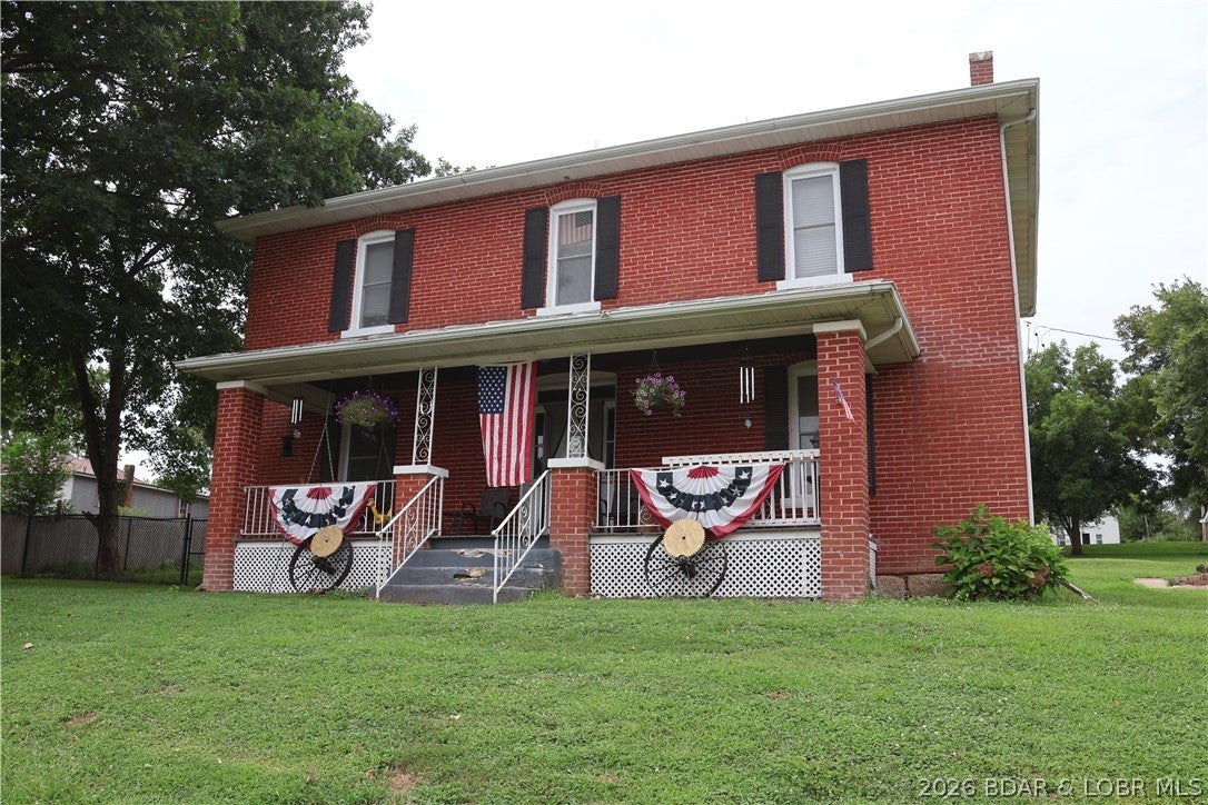 Step into timeless character and modern comfort with this beautiful brick farmhouse, originally built in 1902. This charming home features soaring ceilings, luxury vinyl plank flooring, four spacious bedrooms, three updated full bathrooms, and an inviting floor plan packed with character. The beautifully updated kitchen offers stainless steel appliances, ample workspace, and modern finishes. The large primary suite includes a private full bathroom, while the updated bathrooms feature beautifully tiled showers. Additional highlights include recessed lighting and a dedicated office space perfect for working from home. Outside, enjoy an oversized lot with a fenced-in yard, perfect for pets, along with a classic front porch made for relaxing in the evenings. A spacious 40' x 30' detached two car garage provides plenty of room for vehicles, storage, a workshop, or hobbies. From its historic brick exterior and classic farmhouse charm to its thoughtful modern updates and generous outdoor space, this home offers a unique combination of character, functionality, and comfort. Don't miss your opportunity to make this one-of-a-kind home yours!