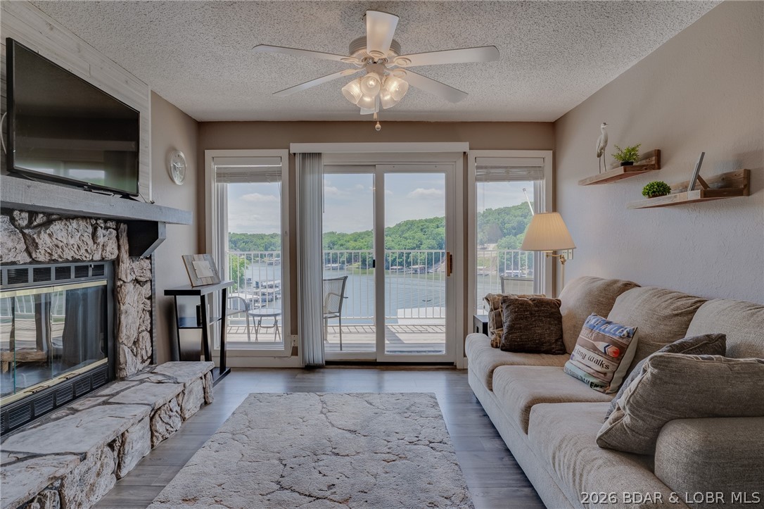 Imagine waking up to spectacular lake views every day in this fully furnished turnkey condo. Offering a bright, modern interior completely updated in 2019, this condo combines contemporary style w/ effortless lakeside living. The heart of the condo is the kitchen, which shines with new white cabinetry, soft-close drawers, pristine countertops, & top-of-the-line stainless steel appliances. LVP flooring & updated LED lighting run throughout, leading you into a cozy living room w/ a beautiful stone fireplace. The floor plan boasts 2 spacious master suites—including one w/ the added convenience of a private entrance—making it ideal for hosting guests or maximizing rental potential. Through dual sets of sliding doors, accessible from both the living room and primary suite, to relax on the expansive covered balcony overlooking the water. Located just 7 steps from the parking lot for incredibly easy access, the property also offers ultimate peace of mind with a completely replaced HVAC installed 06/2020. Boat slips are typically available directly below the complex. Whether you are seeking a personal waterfront sanctuary or an investment property, this turnkey gem delivers on every front.