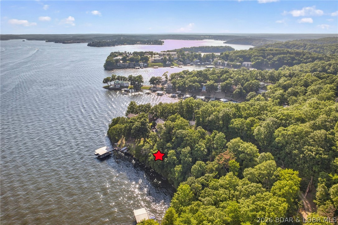 Rare opportunity to own an exceptional waterfront building lot offering 110 feet of lakefront and breathtaking main channel views. The ideal setting to build your dream lake home, or expand your vision by purchasing the adjoining second-tier acreage (MLS #3598458) for additional privacy or future development. Together, the properties offer outstanding potential for a private estate or community-style project with the possibility of a community dock, subject to applicable approvals. Whether you're looking to create the ultimate lake retreat or invest in future possibilities, this is a property you won't want to miss.