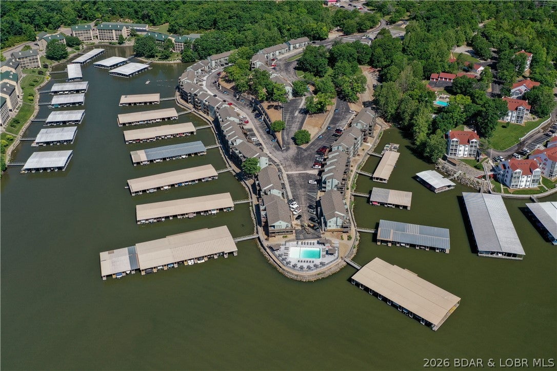 Enjoy stunning main channel side views from the private, open top-deck of this fully furnished, turn-key top-floor condo at Southwood Shores! This move-in ready 2-bedroom, 2-bathroom home features a spacious living room centered around a cozy fireplace, an open kitchen, and includes a 12x36 boat slip. Situated in a quiet cove location, the complex boasts premium amenities including indoor and outdoor pools, a hot tub, tennis and pickleball courts, a clubhouse, plus a private boat ramp and trailer parking.